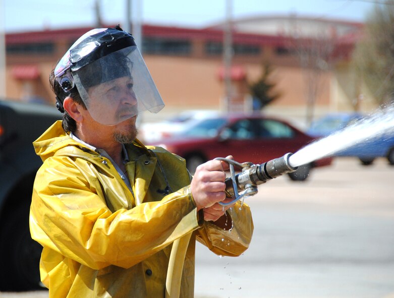 Spencer Cahoon, with the CSC Applied Technologies aircraft maintenance wash rack team, sprays down the A-26 Invader static-display aircraft during its six-month cleaning, March 29. (U.S. Air Force photo/ Joe B. Wiles)