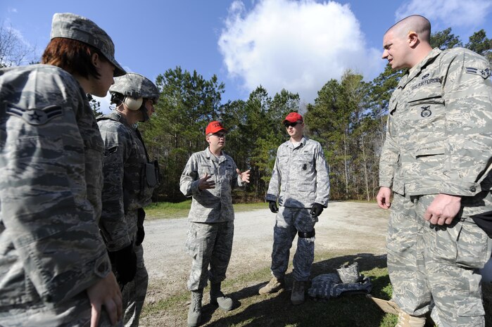 U.S. Air Force Staff Sgt. Shaun Ferguson gives instructions on firing range procedures to 628th Security Forces Squadron members at Joint Base Charleston, S.C., March 26, 2010. In preparation for deployment, combat arms instructors conducted weapons familiarization training with the security forces members. Sergeant Ferguson is a combat arms instructor with the 628 SFS. (U.S. Air Force photo by James M. Bowman/released)