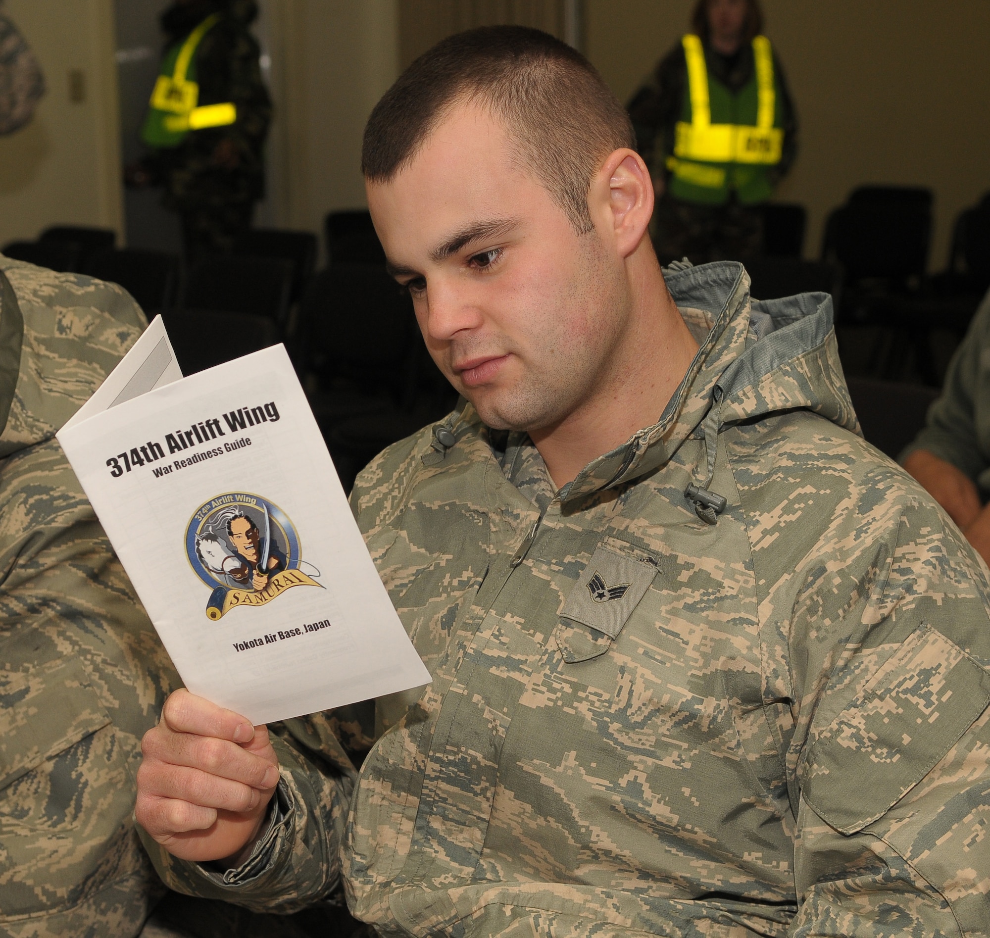 YOKOTA AIR BASE, Japan -- Senior Airman Michael David, 374th Maintenance Squadron, reads through a War Readiness Guide Mar. 30, during an operational readiness exercise. This guide highlights important information personnel need to know when arriving at Yokota. (U.S. Air Force photo/Airman 1st Class Sean Martin)