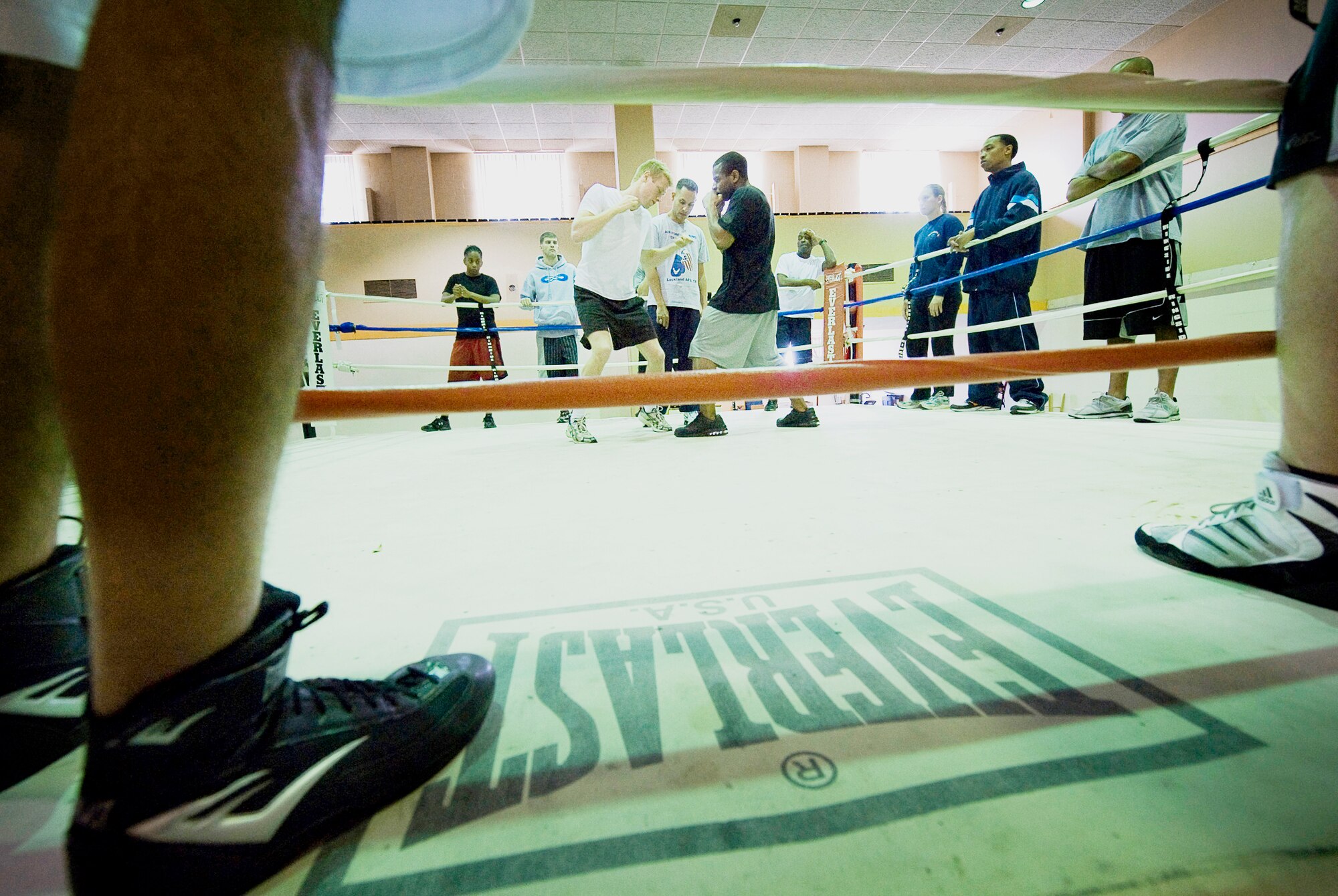 Air Force boxing team hopefuls Jarrett Johnson and James Beck work on delivering body blows while boxing coach Steven Franco oversees the servicewide camp March 23, 2010, at Lackland Air Force Base, Texas. (U.S. Air Force photo/Senior Airman Christopher Griffin)