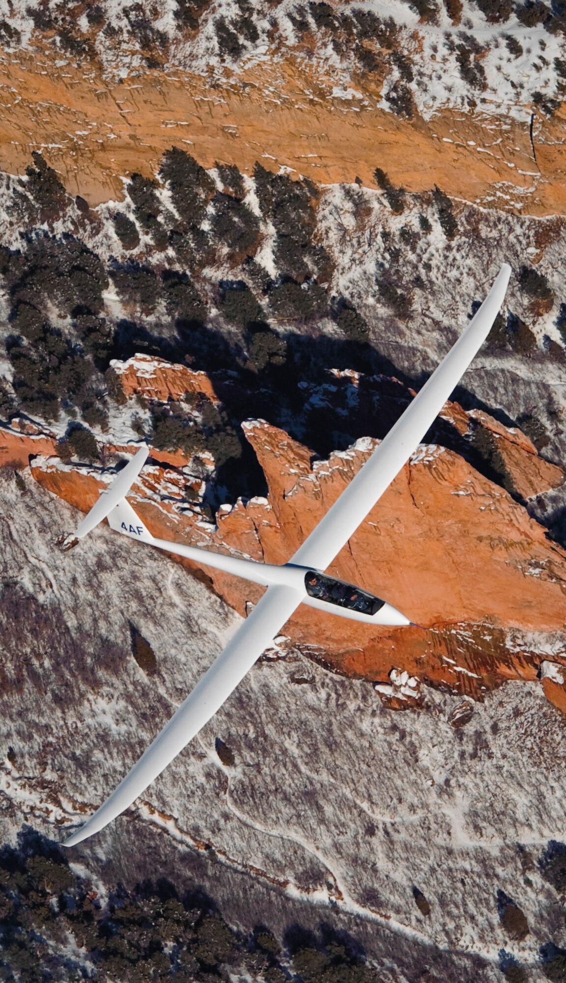 Air Force Academy cadets fly in a TG-15A glider over Colorado Springs, Colo., Feb. 23, 2010. Cadets typically fly 10-15 training sorties in the TG-15A and undergo 50-hour cross-country upgrade training before they can fly cross-country solo in the TG-15B. The 94th Flying Training Squadron conducts more than 30,000 sorties per year in support of the Academy Soaring Program. (U.S. Air Force photo/Tech. Sgt. Samuel Bendet)