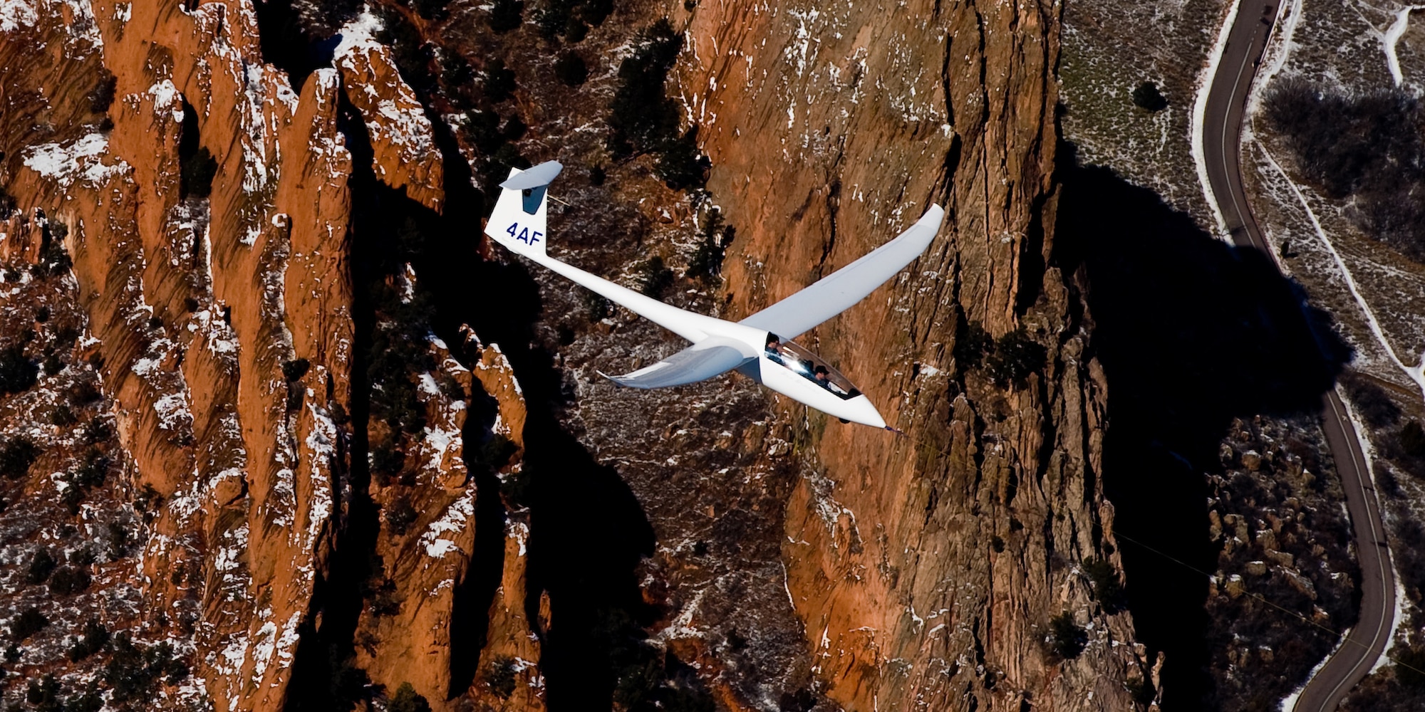 Air Force Academy cadets fly in a TG-15A glider over Colorado Springs, Colo., Feb. 23, 2010. Cadets typically fly 10-15 training sorties in the TG-15A and undergo 50-hour cross-country upgrade training before they can fly cross-country solo in the TG-15B. The 94th Flying Training Squadron conducts more than 30,000 sorties per year in support of the Academy Soaring Program. (U.S. Air Force photo/Tech. Sgt. Samuel Bendet)