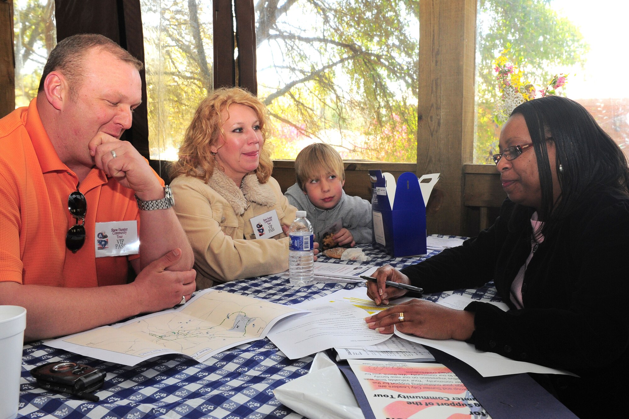 SHAW AIR FORCE BASE, S.C. -- Minerva Paige, U.S. Air Force Central Command, talks to Staff Sgt. Jimmy Blackwell, 3rd Army assistant operations NCO, and his wife, Cherrie, and son, Hunter, about the different schools in the surronding area, March 27. (U.S Air Force Photo/Senior Airman David Minor)