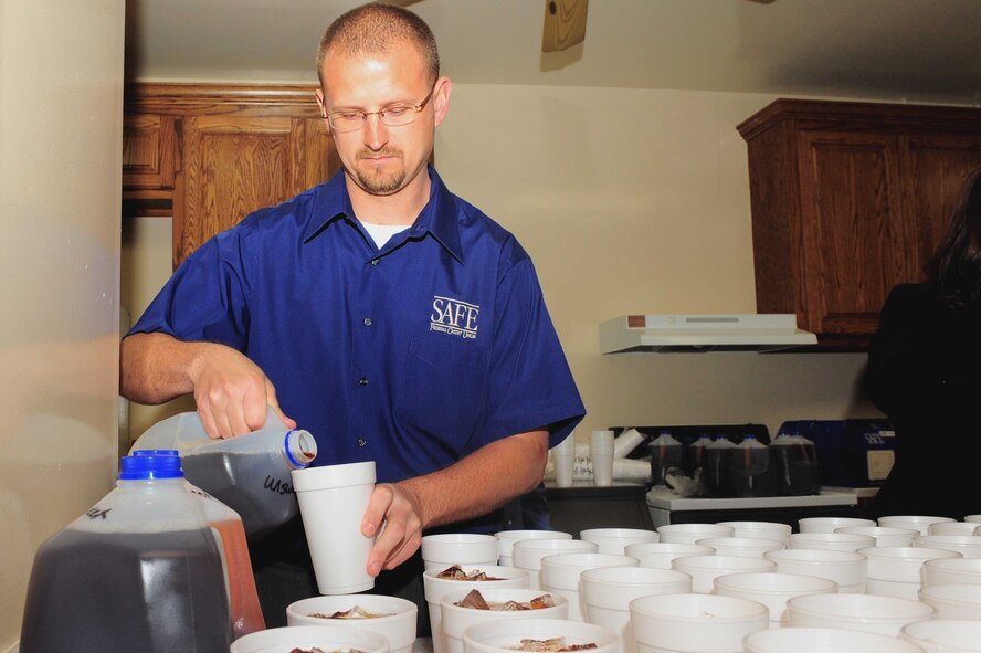SHAW AIR FORCE BASE, S.C. -- Michael Baker, SAFE Bank, pours a glass of tea as he prepares for the arrival of the U.S. Army Central Comand visitors at a luncheon March 27. (U.S Air Force Photo/Senior Airman David Minor)