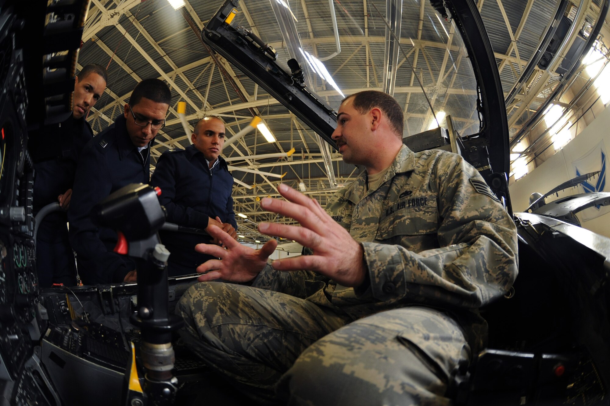 MOODY AIR FORCE BASE, Ga. -- Staff Sgt. Thomas Breining, 23rd Equipment Maintenance Squadron dock coordinator, explains how the gauges work inside the cockpit of an A-10C Thunderbolt II to cadets from the University of Puerto Rico Air Force ROTC Detachment 755 here March 24. They were also able to see an A-10C while it was being repaired. (U.S. Air Force photo by Airman 1st Class Benjamin/RELEASED)