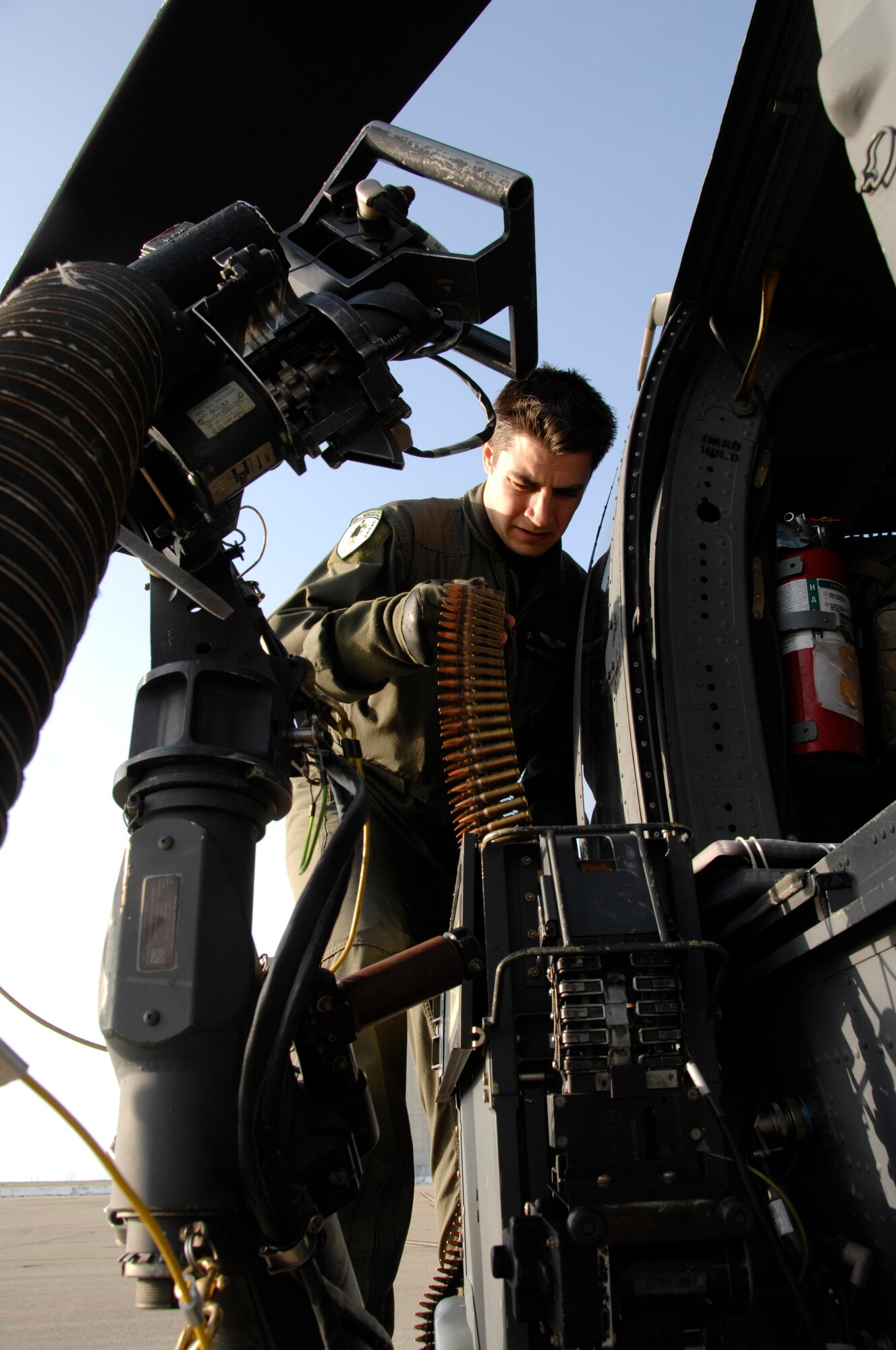 Staff Sgt. Sean Pellaton, an HH-60G Pave Hawk aerial gunner from the 129th Rescue Squadron, conducts a preflight inspection on a GAU-2C Mini-gun at Moffett Federal Airfield, Calif., March 24, 2010. (Air National Guard photo by Tech. Sgt. Ray Aquino)