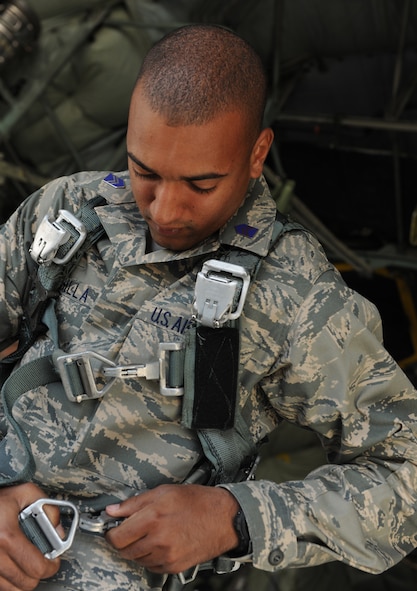 MOODY AIR FORCE BASE, Ga. -- Cadet 3rd Class Bruce Padilla from the University of Puerto Rico Air Force ROTC Detachment 755, straps on a harness attached to a C-130E Hercules during a base visit here March 23. Cadets from Detachment 775 are required to visit an Air Force base at least once during their time in the ROTC program. (U.S. Air Force photo by Airman 1st Class Benjamin Wiseman/RELEASED)