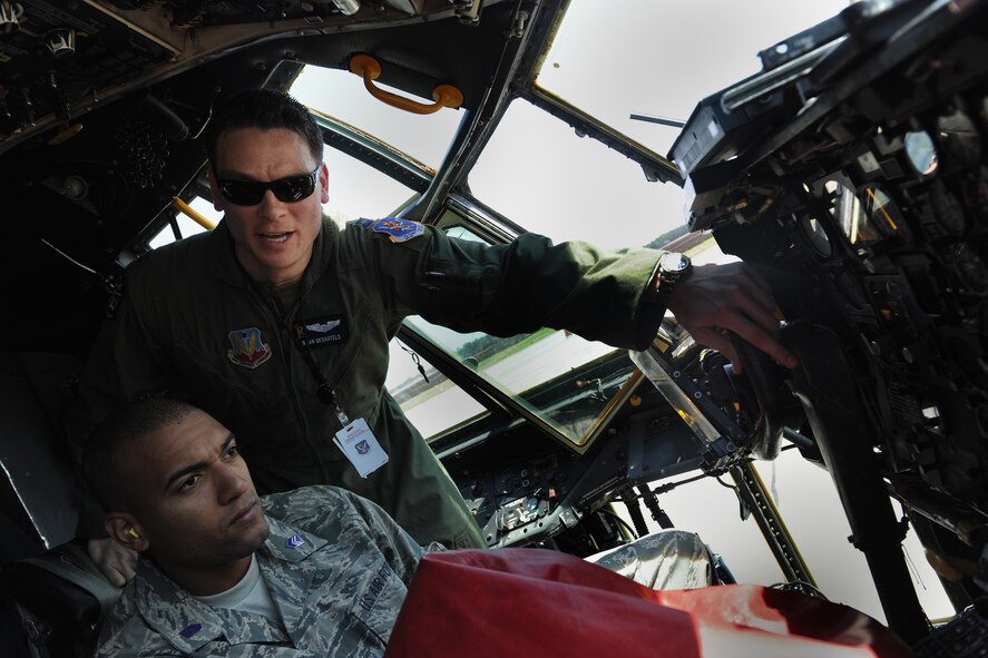 MOODY AIR FORCE BASE, Ga. -- Capt. Brian Desautels, 71st Rescue Squadron mobility flight commander, gives a tour of a C-130E Hercules cockpit to Cadet 3rd Class Bruce Padilla from the University of Puerto Rico Air Force ROTC Detachment 755 during a base tour here March 23. During the tour, cadets were able to see many the different career fields that the Air Force has to offer. (U.S. Air Force photo by Airman 1st Class Benjamin Wiseman/RELEASED) 