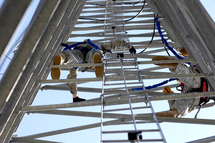 U.S. Air Force Airman 1st Class Amos Hommel, left, and Senior Airman Riley Cusson take a break while climbing the radio tower on Joint Base Charleston, S.C., March 23, 2010. The Airmen climbed the tower to maintain climbing certification and to check the line-of-sight to Naval Weapons Station Charleston. Airmen Hommel and Cusson are radio frequency transmission systems specialists with the 628th Communications Squadron. (U.S. Air Force Photo/Airman 1st Class Lauren Main)