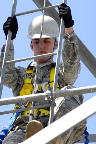 U.S. Air Force Airman 1st Class Amos Hommel begins his ascent up the radio tower on Joint Base Charleston, S.C., March 23, 2010. The 110-foot climb requires extensive safety measures, such as a hard hat, gloves, harness and lanyard. Lanyards which have been subject to impact loading from afall or a weight test are removed from service and destroyed. Airman Hommel is a radio frequency transmission systems specialist with the 628th Communications Squadron. (U.S. Air Force photo/Airman 1st Class Lauren Main)