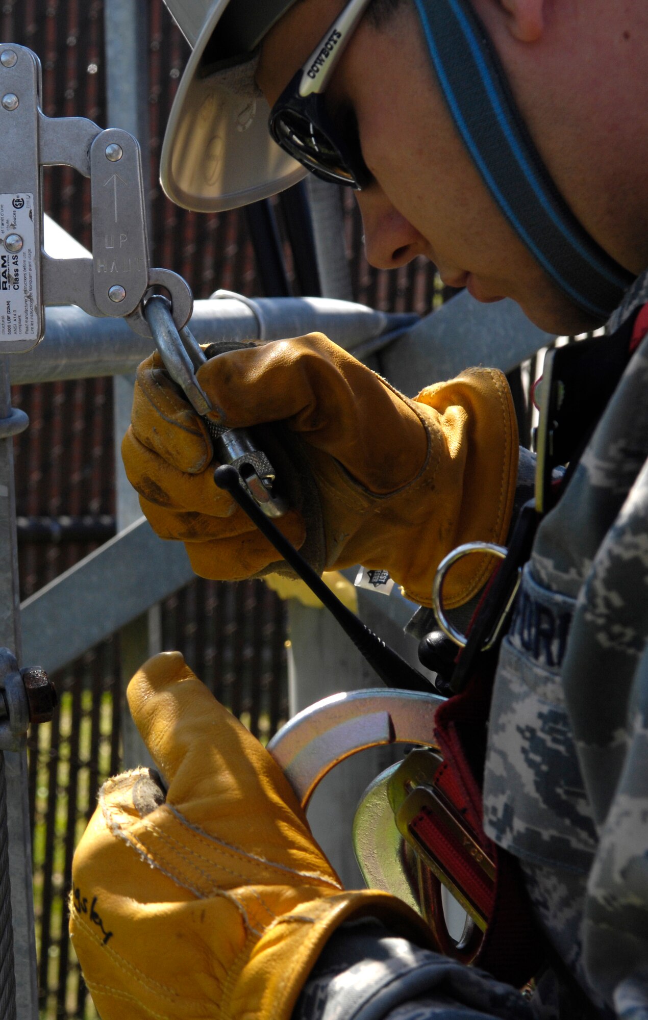 U.S. Air Force Senior Airman Riley Cusson prepares to climb the radio tower on Joint Base Charleston, S.C., March 23, 2010. Airman Cusson climbed the tower to maintain his certification and to check line-of-sight to Naval Weapons Station Charleston. Airman Cusson is a radio frequency transmission systems specialist with the 628th Communications Squadron. (U.S. Air Force Photo/Airman 1st Class Lauren Main)