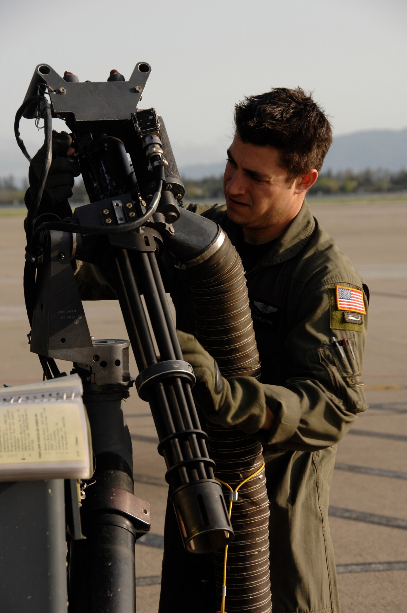 Staff Sgt. Sean Pellaton, an HH-60G Pave Hawk aerial gunner from the 129th Rescue Squadron, conducts a pre-flight inspection on a GAU-2C Mini-gun at Moffett Federal Airfield, Calif., March 24, 2010. (Air National Guard photo by Tech. Sgt. Ray Aquino)