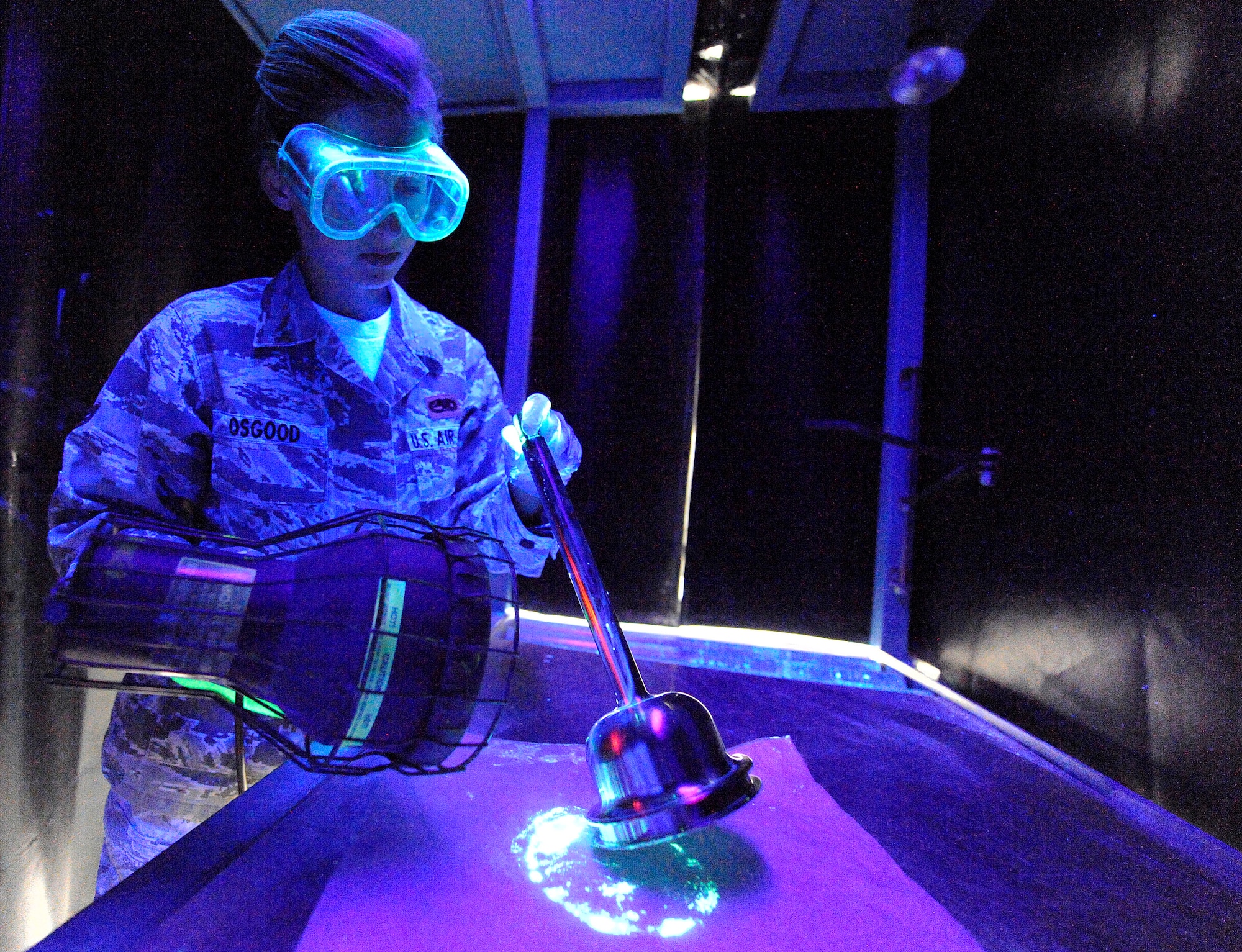 LANGLEY AIR FORCE BASE, Va.- Airman 1st Class Danna Osgood, 1st Equipment Maintenance Squadron Non-Destructive Inspection apprentice, inspects an F-15C Eagle bell house hydraulic component March 22. NDI inspects for cracks and flaws on aircraft and their components, aerospace ground equipment, safety equipment and also tests jet engine oil samples, using a variety of methods, like magnetic particle, fluorescent penetrant, eddy current, radiography, optical and ultrasonic equipment. (U.S. Air Force photo/ Senior Airman Dana Hill)