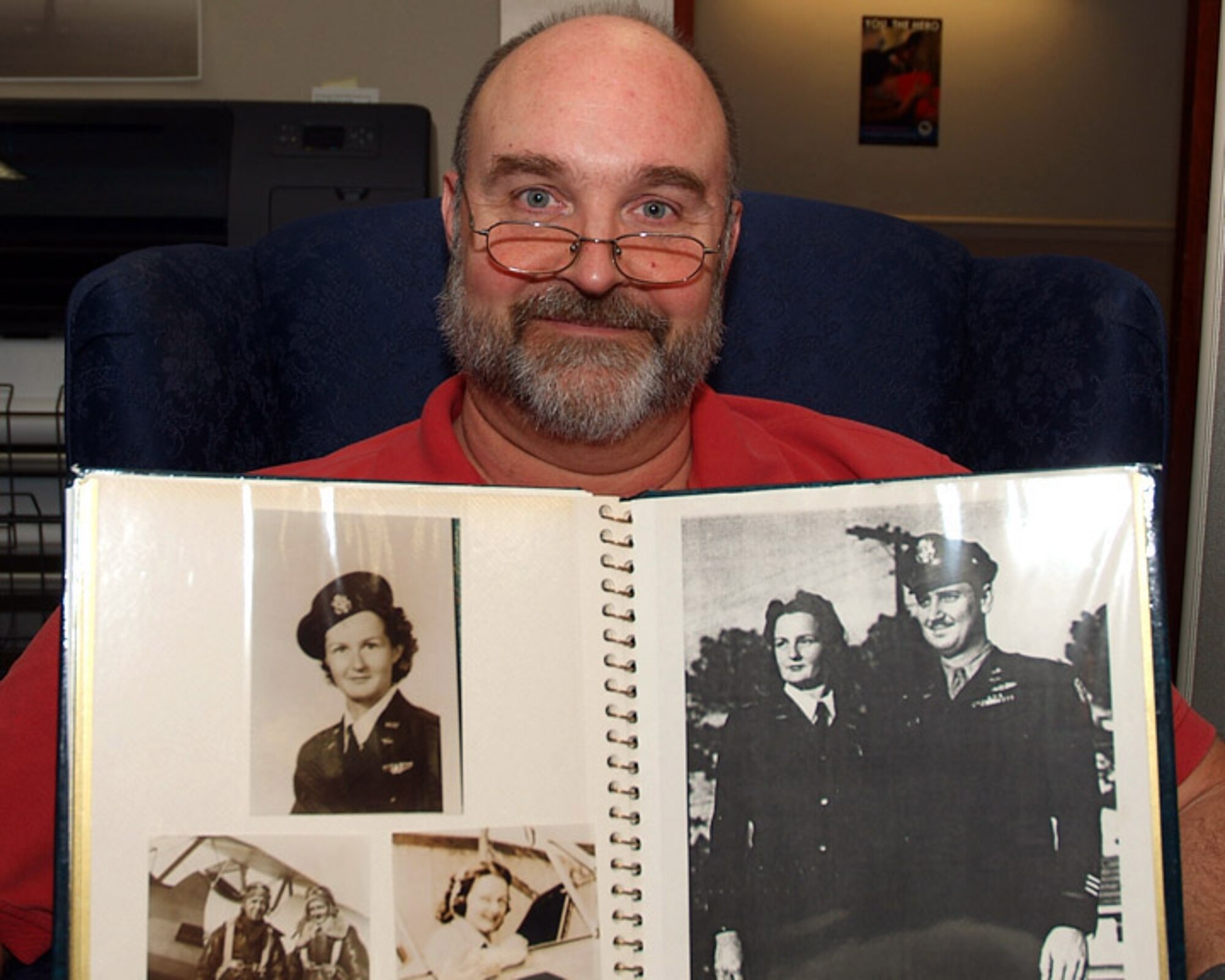 HURLBURT FIELD, Fla. -- Rich Williams, a civilian employee at Hurlburt Field, holds a photo album showing his mother, Lesley Stroud Williams, when she flew for the Women Airforce Service Pilots program during World War II. The WASP were awarded the Congressional Gold Medal in recognizition of their service, which was kept under wraps for decades. The medal ceremony took place in Washington, D.C., March 10, during Women's History Month. (Air Force photo/Keith Keel)