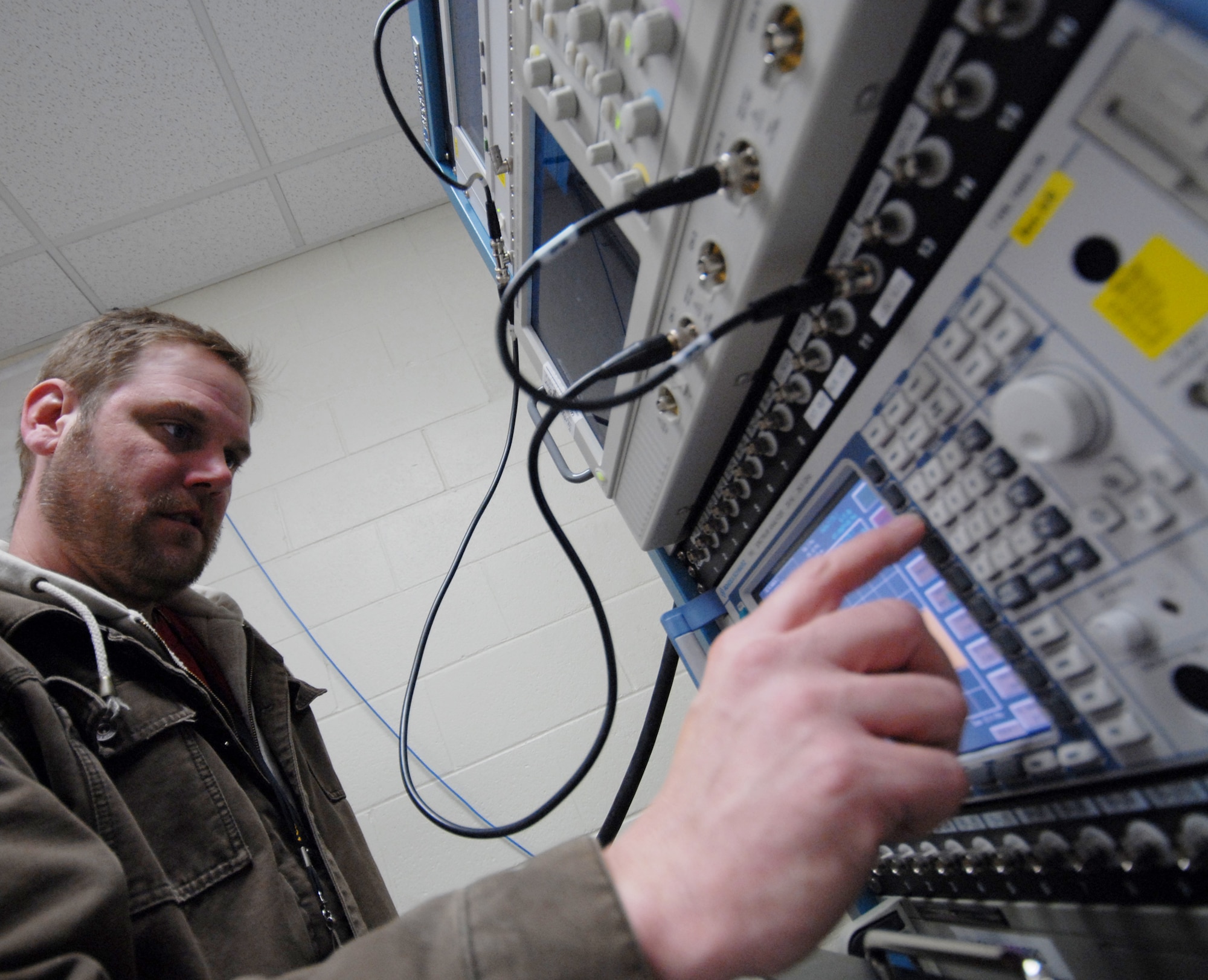 Kevin McNeal, 68th Electronic Warfare Squadron contractor, prepares the Advanced Integrated Defense Electronic Warfare System test lab for a test run.  Members of the Advanced Systems Flight of the 68th EWS, work closely with their foreign customers to facilitate future requirements so their mission data can be tailored to the ever-changing threat environment and define customer's necessities to build future products.(U.S. Air Force photo/Samuel King Jr.) 