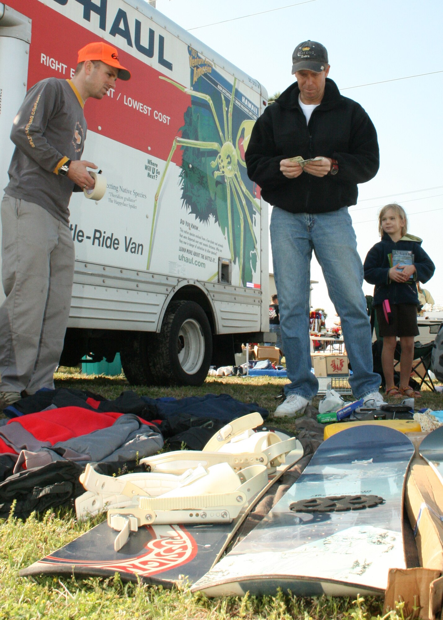 EGLIN AIR FORCE BASE, Fla. - A father looks at snowboards for his family during the base annual yard sale March 27. Hundreds of shoppers and around 60 vendors came out to look for good deals. Families brought old items along with crafts to sell at the event. (U.S. Air Force photo/ 2nd Lt. Andrew Caulk)