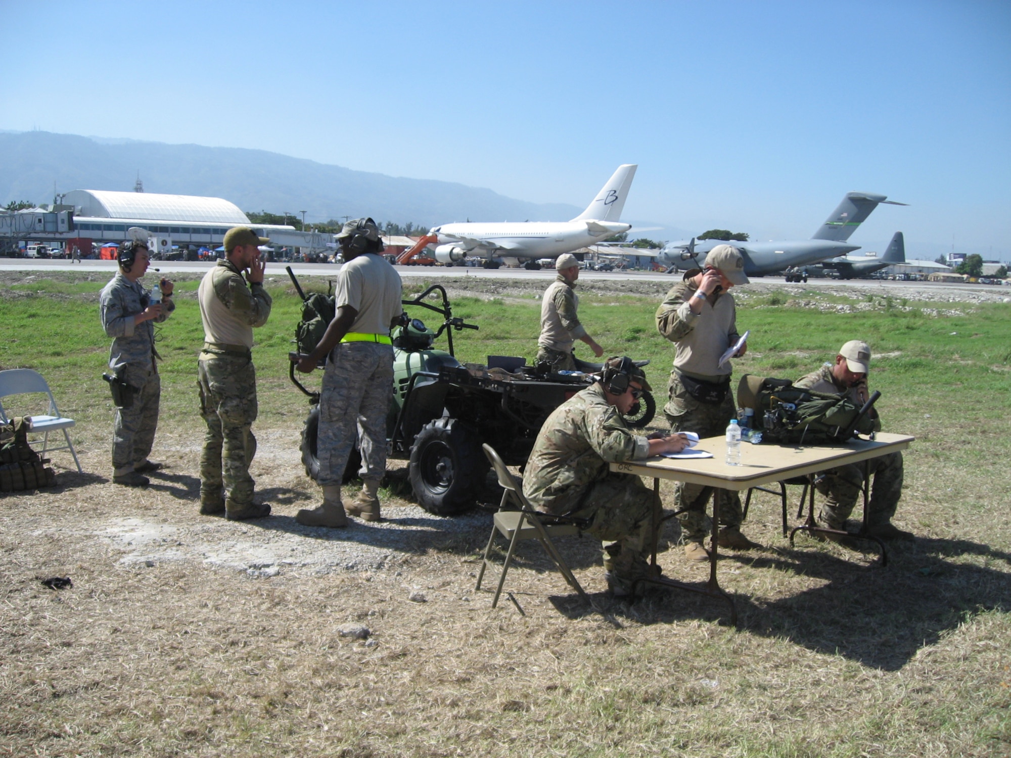 Aviation experts from various U.S. agencies work under austere conditions to ensure ramp operations and slot times are processed for inbound and outbound air traffic into Haiti’s Toussaint Louverture International Airport after a 7.0 magnitude earthquake hit the island nation Jan. 12, 2010.  (Federal Aviation Administration photo courtesy of Kenneth Langert)