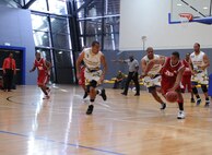 U.S. Army Private 2nd Class Thomas Wright, Mannheim Mustangs, drives the ball to the goal during a U.S. Forces Europe Basketball Championships, Ramstein Air Base, Germany, March 24, 2010. The 86th Services Squadron hosted the U.S. Armed Forces Europe Men's and Women's basketball championship series, a tournament consisting of U.S. servicemembers, dependents and retirees from around the European Theater. (U.S. Air Force photo by Airman 1st Class Caleb Pierce)
