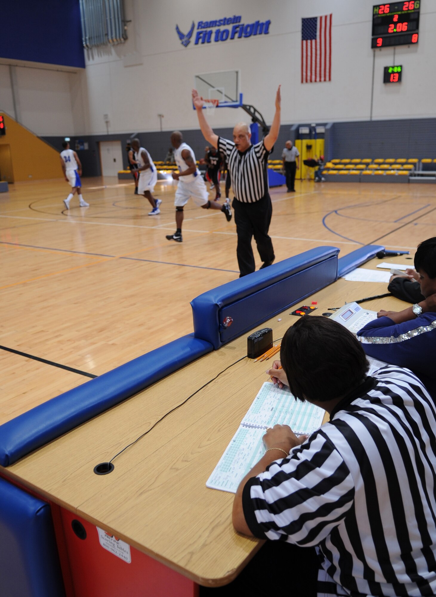 Officials keep statistics throughout a U.S. Forces Europe basketball game, Ramstein Air Base, Germany, March 24, 2010. The 86th Services Squadron hosted the U.S. Armed Forces Europe Men's and Women's basketball championship series, a tournament consisting of U.S. servicemembers, dependents and retirees from around the European Theater. (U.S. Air Force photo by Airman 1st Class Caleb Pierce)
