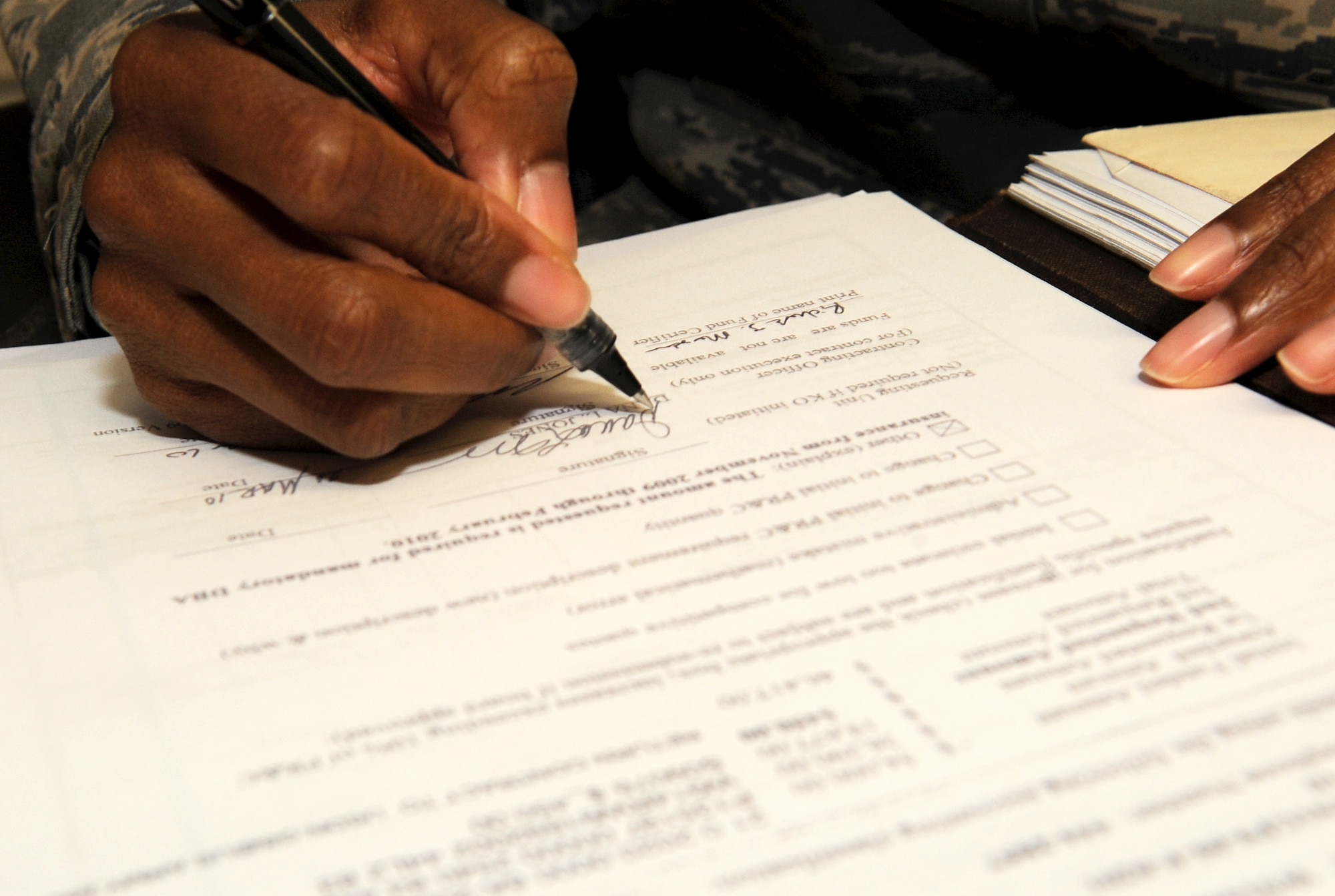 Tech. Sgt. Dana Jones, Joint Contracting Command – Iraq contracting officer, awards a contract on Kirkuk Regional Air Base, Iraq on March 24, 2010.  The JCC contracting officers act as business advisors for units regarding contract purchases.   Sergeant Jones is deployed from Minot AFB, N.D.   (U.S. Air Force photo/Staff Sgt. Tabitha Kuykendall/Released)