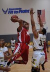 U.S. Army Private 2nd Class Thomas Wright, Mannheim Mustangs, drives the ball to the goal during a U.S. Forces Europe Basketball Championships, Ramstein Air Base, Germany, March 24, 2010. The 86th Services Squadron hosted the U.S. Armed Forces Europe Men's and Women's basketball championship series, a tournament consisting of U.S. servicemembers, dependents and retirees from around the European Theater. (U.S. Air Force photo by Airman 1st Class Caleb Pierce)