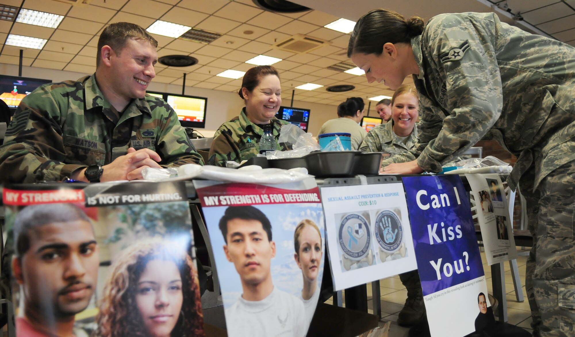 SPANGDAHLEM AIR BASE, Germany -- Airman 1st Class Jennifer Schmermund, right, 52nd Civil Engineer Squadron operations manager, signs a poster during the bowl-a-thon held at Eifel Lanes Bowling Center March 25.  The event raised $1000 from donations, entry fees and pledges to support sexual assault victims in the local area. (U.S. Air Force photo/Staff Sgt. Heather M. Norris)