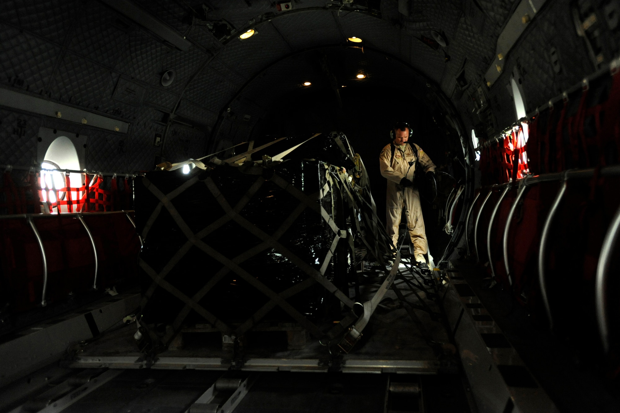 Master Sgt. Chris Ringland, 438th Air Expeditionary Advisory Group standards and evaluation loadmaster, untangles the communication cord for his headset, March 28, 2010, at Camp Bastion, Afghanistan. (U.S. Air Force/ Staff Sgt. Manuel J. Martinez/released) 