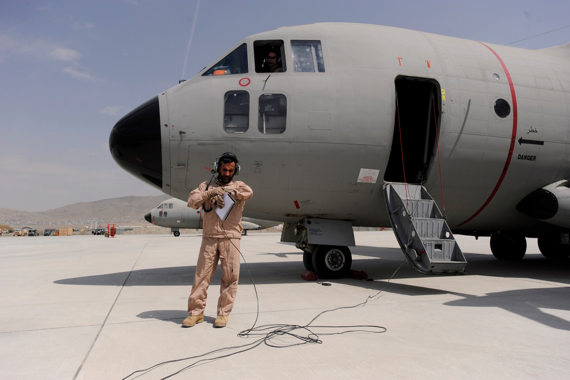 Afghanistan National Army Air Corps Master Sgt. Sheer Aqa Karimi, a C-27A Spartan loadmaster, performs pre-flight checks prior to engine start up for an operational mission and his check ride on a ANAAC C-27, March 28, 2010, at Kabul International Airport, Afghanistan. (U.S. Air Force/ Staff Sgt. Manuel J. Martinez/released) 