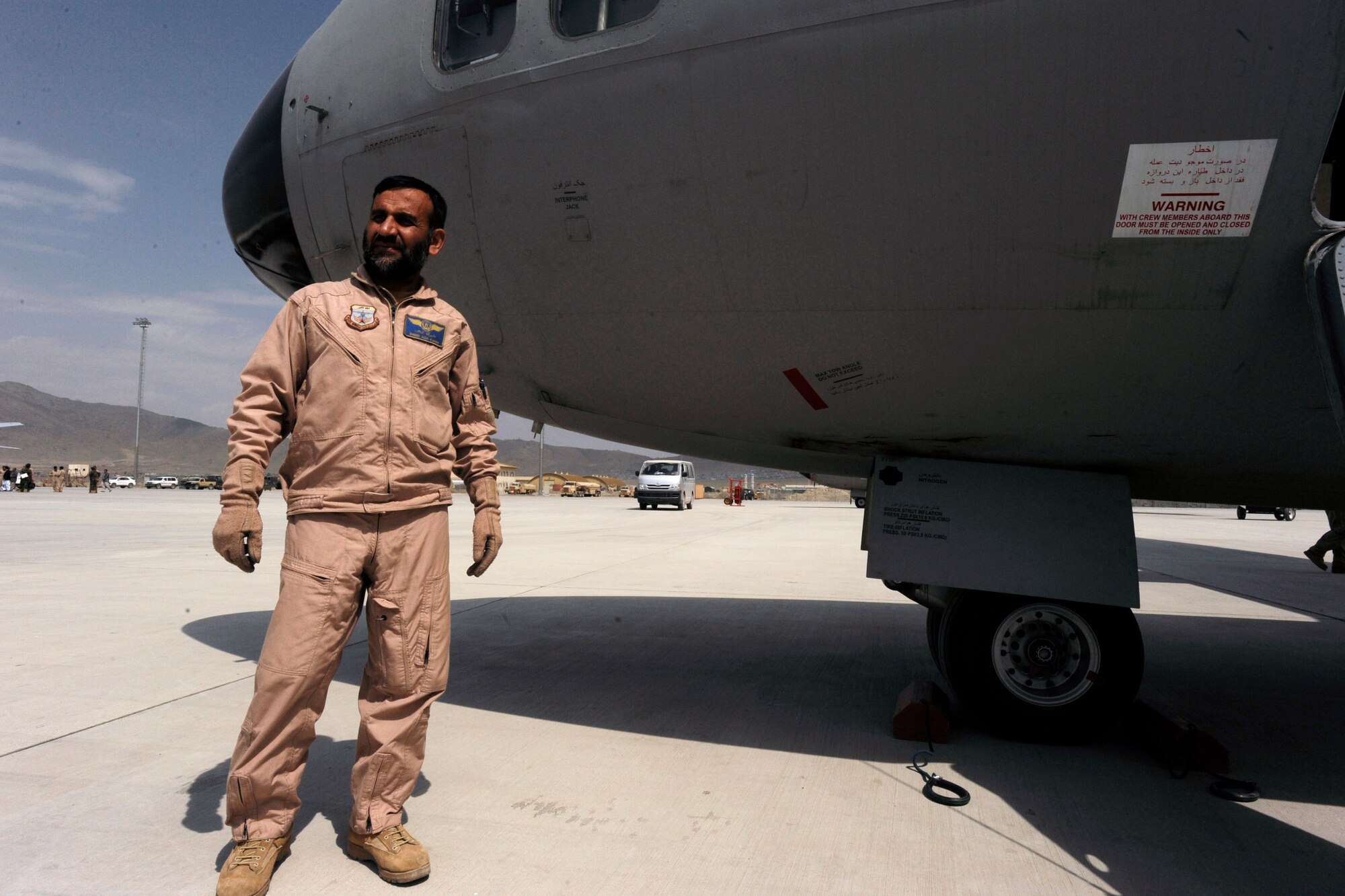 Afghanistan National Army Air Corps Master Sgt. Sheer Aqa Karimi, a C-27A Spartan loadmaster, awaits the arrival of aircraft pilots prior to take off during his check ride on a C-27, March 28, 2010, at Kabul International Airport, Afghanistan. (U.S. Air Force/ Staff Sgt. Manuel J. Martinez/released) 