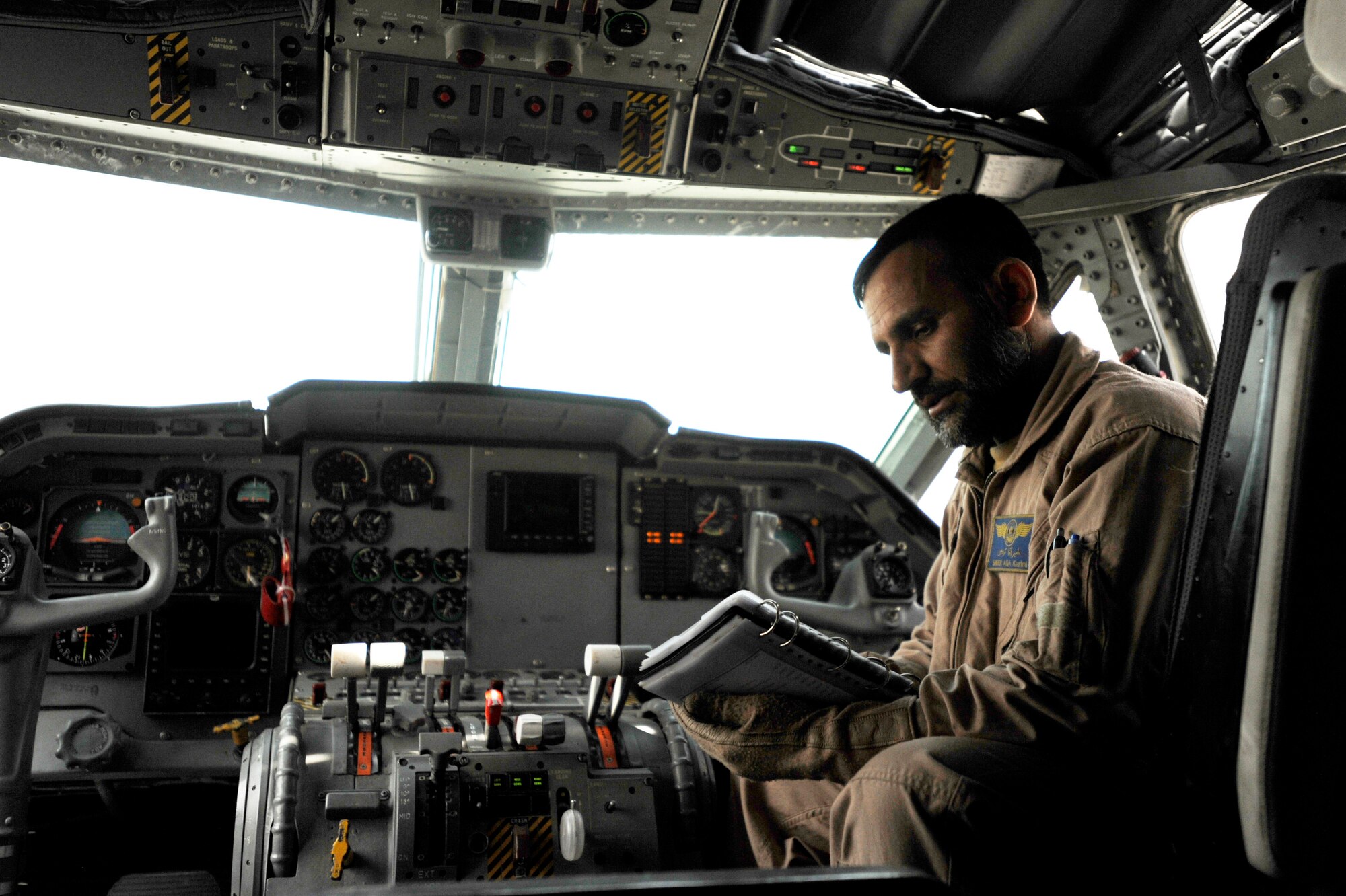 Afghanistan National Army Air Corps Master Sgt. Sheer Aqa Karimi, a C-27A Spartan Loadmaster, reviews checklist items during his check ride aboard a C-27, March 28, 2010 at Kabul International Airport, Afghanistan.  U.S. Airmen from the 538th Air Expeditionary Advisory Squadron and Afghan soldiers with the Afghanistan National Army Air Corps reached another historic milestone after completing a successful check ride for the nation's first qualified C-27A Spartan loadmaster. (U.S. Air Force/ Staff Sgt. Manuel J. Martinez/released)  