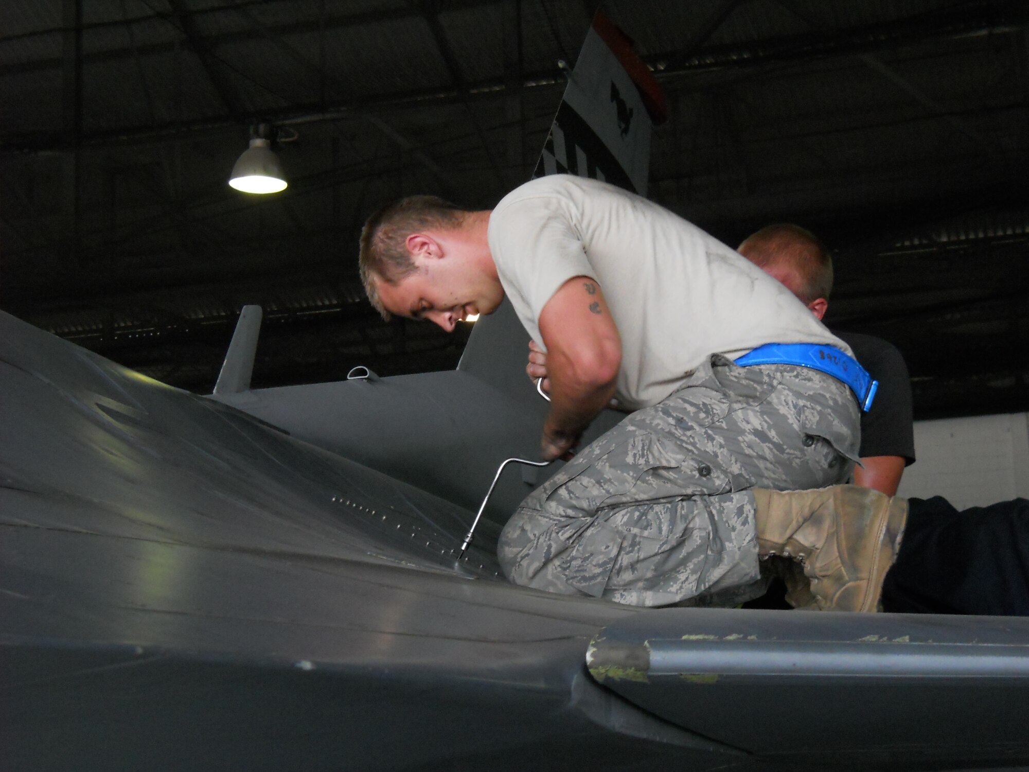 Senior Airman Michael George, 51st Maintenance Squadron, performs F-16 Fighting Falcon maintenance during Commando Sling 10 at Paya Lebar Air Base, Singapore. (Courtesy photo)