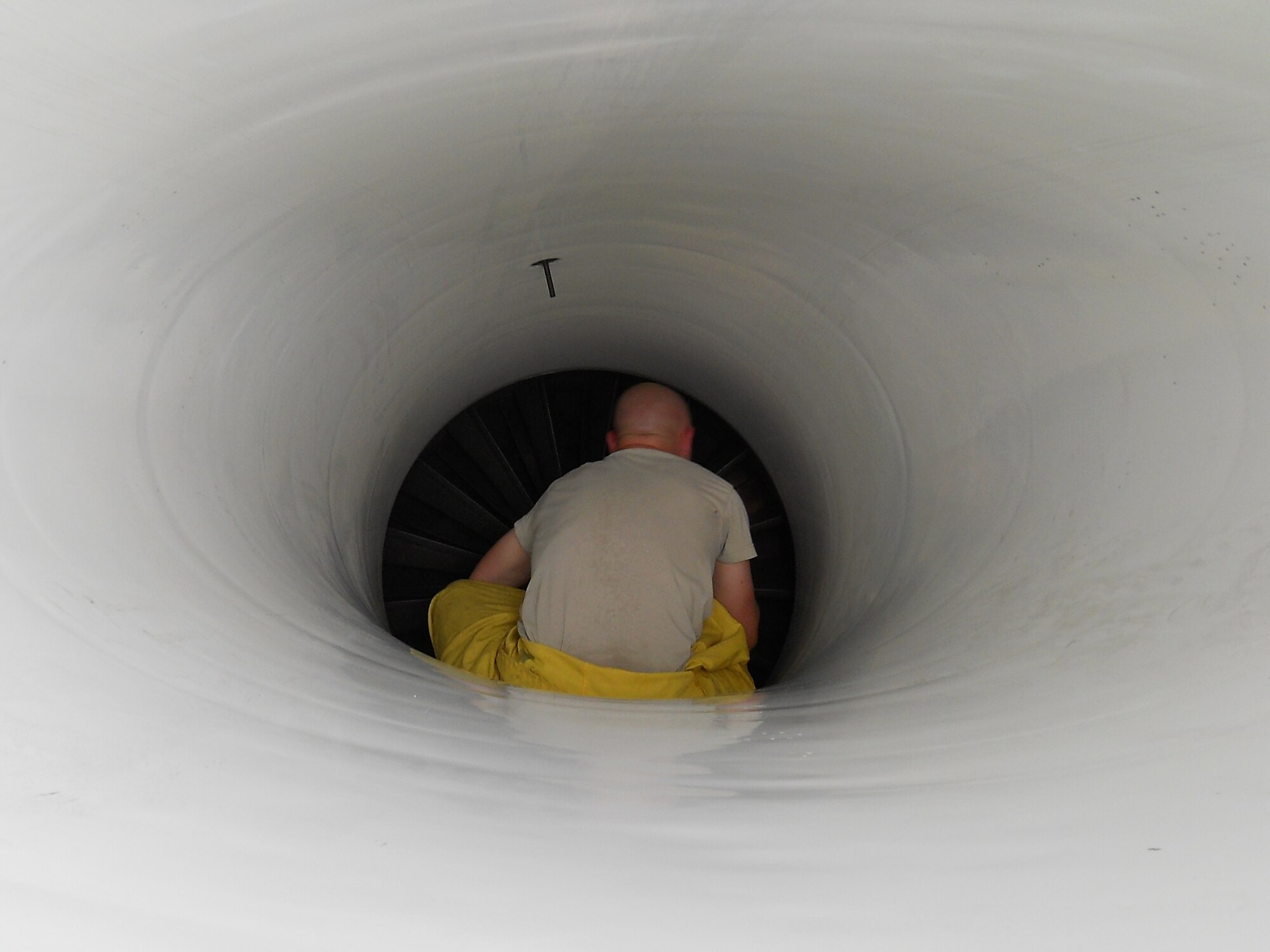 Staff Sgt. Wade Woodard, 36th Aircraft Maintenance Unit, performs a post-flight intake inspection of an F-16 Fighting Falcon during Commando Sling 10 at Paya Lebar Air Base, Singapore. (Courtesy photo)