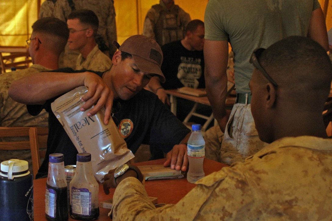 NFL players Drew Brees from the New Orleans Saints, Billy Miller from the New Orleans Saints, and Donnie Edwards from the Kansas City Chiefs visit Marines from 24th Marine Expeditionary Unit in Djibouti, Africa as part of a USO tour March 29, 2010.  Marines had a chance to get autographs, and show the players some of the training the Marines have been participating in while in Djibouti.  Players also had a chance to get some hands on training from some of the Marines.  Marines and Sailors of the 24th MEU are conducting a series of sustainment and joint training exercises in Djibouti while deployed with the Nassau Amphibious Ready Group as the theater reserve for Central Command.   (U.S. Marine Corps photo by Gunnery Sgt James Frank)