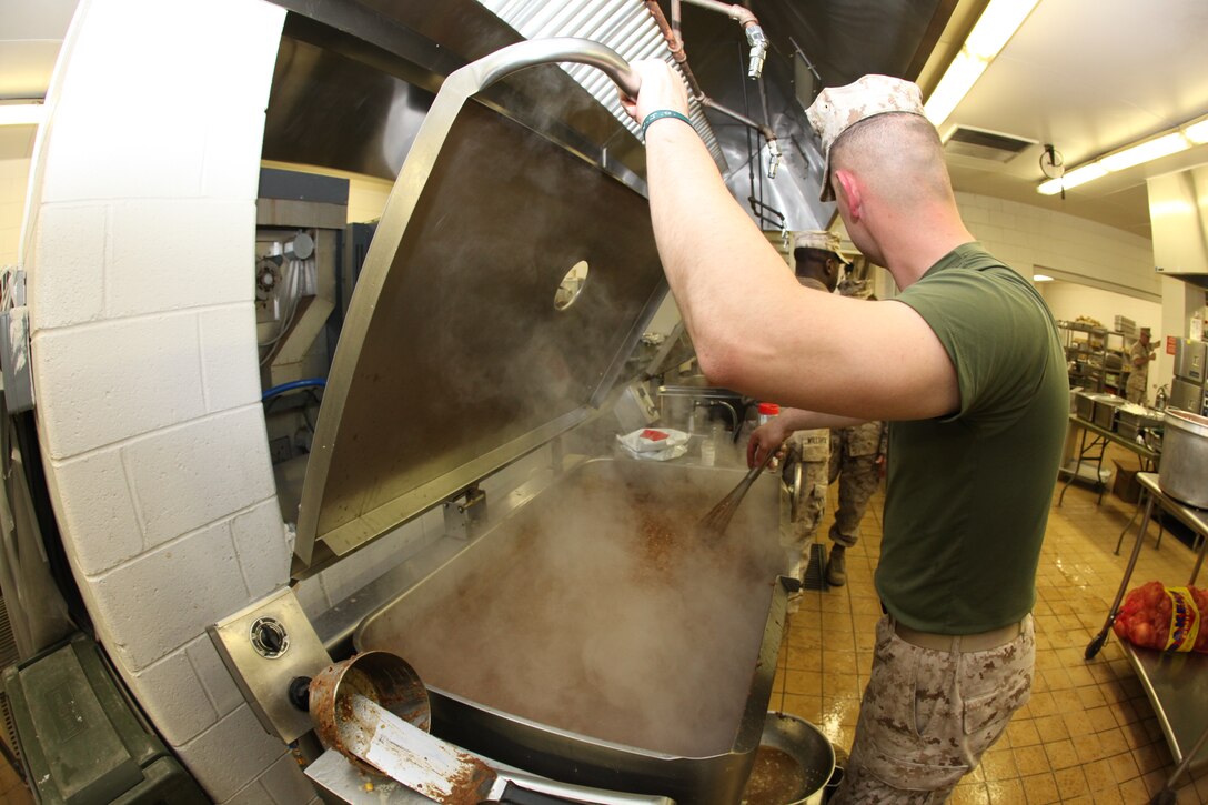 Lance Cpl. Patrick P. Corey, a food service specialist with 26th Marine Expeditionary Unit’s Combat Logistics Battalion 26, prepares evening chow at a mess hall during the MEU’s exercise aboard Fort Pickett, Va., March 30, 2010. The exercise is the first in a series of training evolutions for the MEU that will culminate in its deployment aboard the ships of the Kearsarge Amphibious Ready Group in the fall. (Official United States Marine Corps Photo by Lance Cpl. Santiago G. Colon Jr.) (Released)::r::::n::