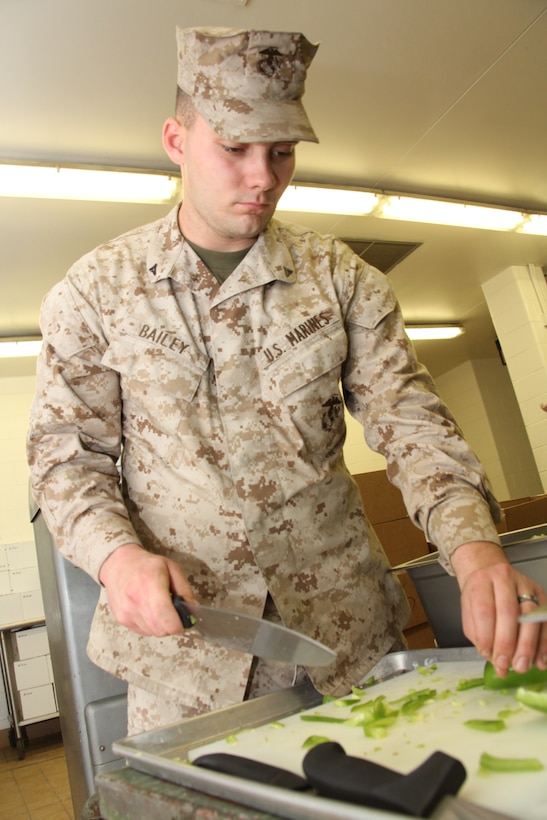 Lance Cpl. Eric W. Bailey, a food service specialist with 26th Marine Expeditionary Unit’s Battalion Landing Team 3/8, chops vegetables for evening chow at a Fort Pickett mess hall during the MEU’s exercise aboard Fort Pickett, Va., March 30, 2010. The exercise is the first in a series of training evolutions for the MEU that will culminate in its deployment aboard the ships of the Kearsarge Amphibious Ready Group in the fall. (Official United States Marine Corps Photo by Lance Cpl. Santiago G. Colon Jr.) (Released)::r::::n::