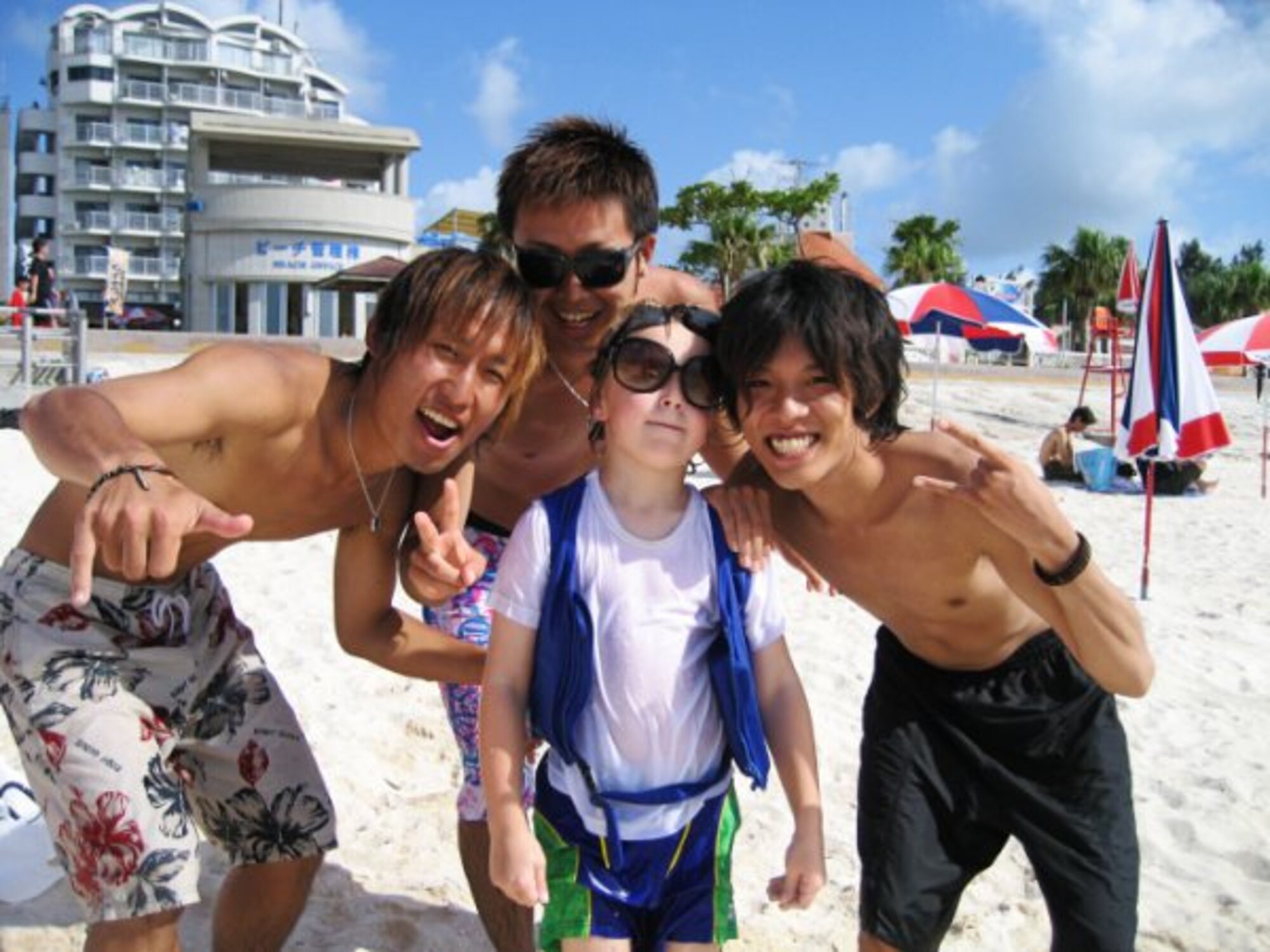 Mrs. Nikki Pedersen, the wife of Senior Airman Christopher Pedersen, a boom operator with Kadena's 909th Aerial Refueling Squadron, received a Kariyushi award for this photo of her son with three Japanese at the beach. The "My Okinawa" photography competition was sponsored by the Ministry of Foreign Affairs of Japan. (Courtesy photo / Mrs. Nikki Pedersen)