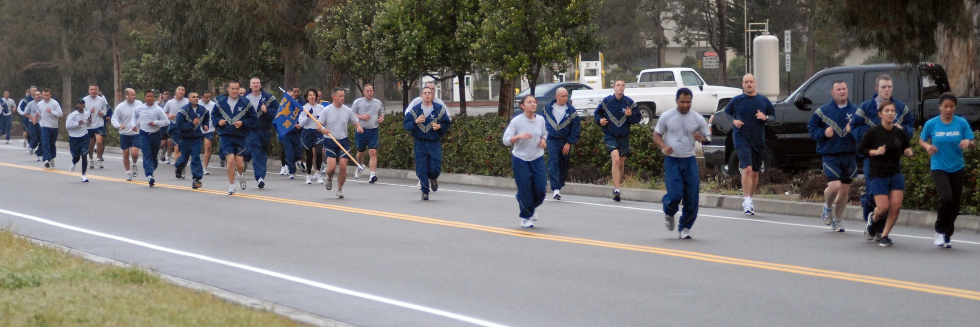 VANDENBERG AIR FORCE BASE, Calif. -- As the hazy morning progresses into rain, the runners participating in the April Awareness Month Kick-off Run make their way down Washington Avenue here Tuesday, March 30, 2010. The run was meant to spread awareness of child abuse, sexual assault, alcohol abuse and the Month of the Military Child. (U.S. Air Force photo/Airman 1st Class Angelina Drake)