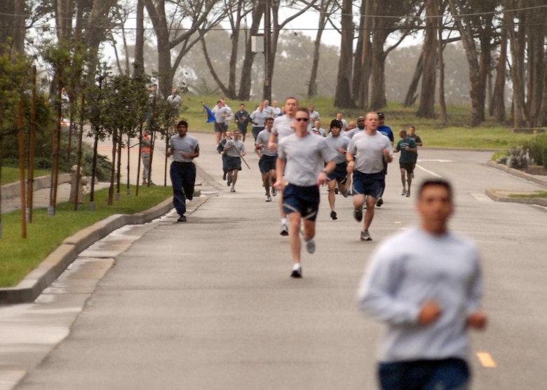 VANDENBERG AIR FORCE BASE, Calif. -- Making their way down Nebraska Avenue, 30th Space Wing runners taking part in the April Awareness Month Kick-off Run follow the lead of a security forces vehicle here Tuesday, March 30, 2010. The four stretches of paved road combined make the run approximately three miles. (U.S. Air Force photo/Airman 1st Class Angelina Drake)