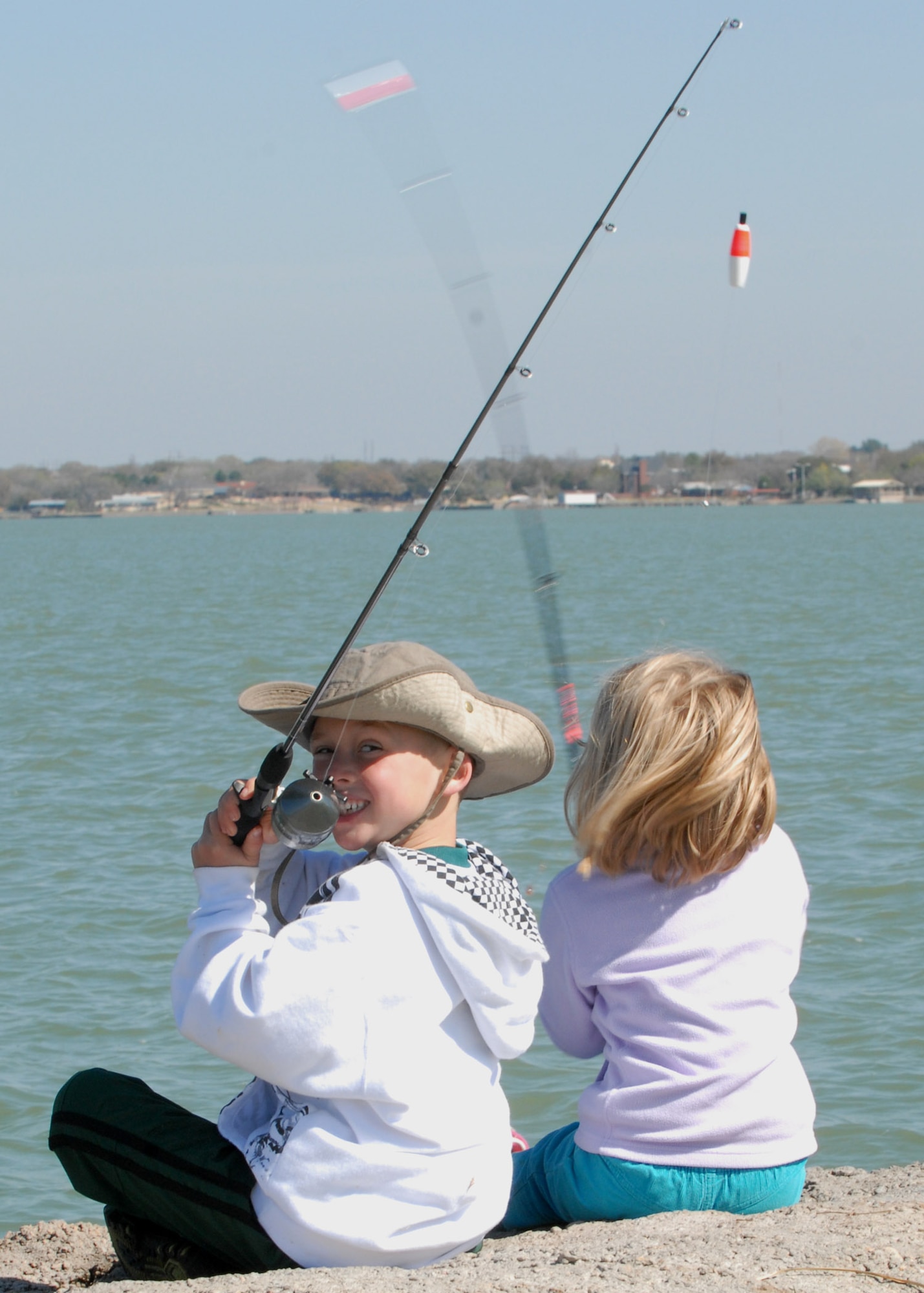 GOODFELLOW AIR FORCE BASE, Texas--Elliot Jensen, 6, gets ready to cast his line during a youth fishing clinic at the Goodfellow Recreation Camp, March 18. Elliot is joined by Sierra Fridley, 4, who is also learning to fish. More than 20 youth age 4-9 attended the clinic, in preparation for a recreation camp fishing derby in May. (U.S. Air Force photo/ Senior Airman Tong Duong)