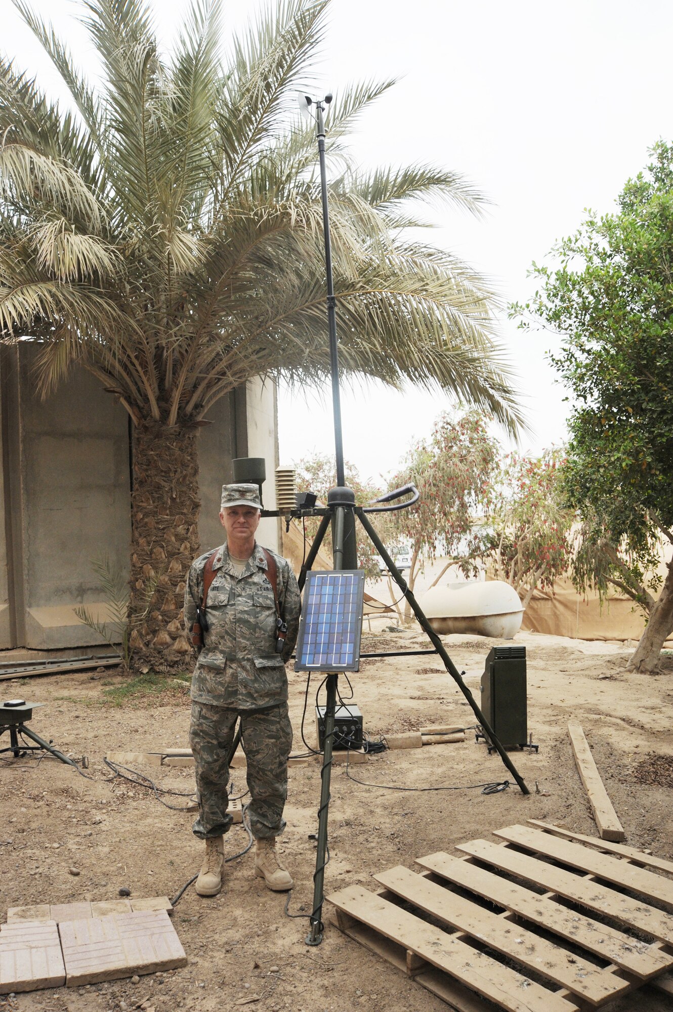 Air Force Major Barry Hunte, 321st Air Expeditionary Advisory Group Air Operations Center weather advisor, stands next to the Tactical Meteorological Observation System used during the 52-day course to train the first class of Iraqi air force meteorology officers.  The class graduated March 25, 2010 at Camp Victory, Iraq.  During the course, the eight Iraqi military students were instructed on everything from basic weather observations to advanced weather forecast models. (U.S. Air Force photo/Master Sgt. Trish Bunting)