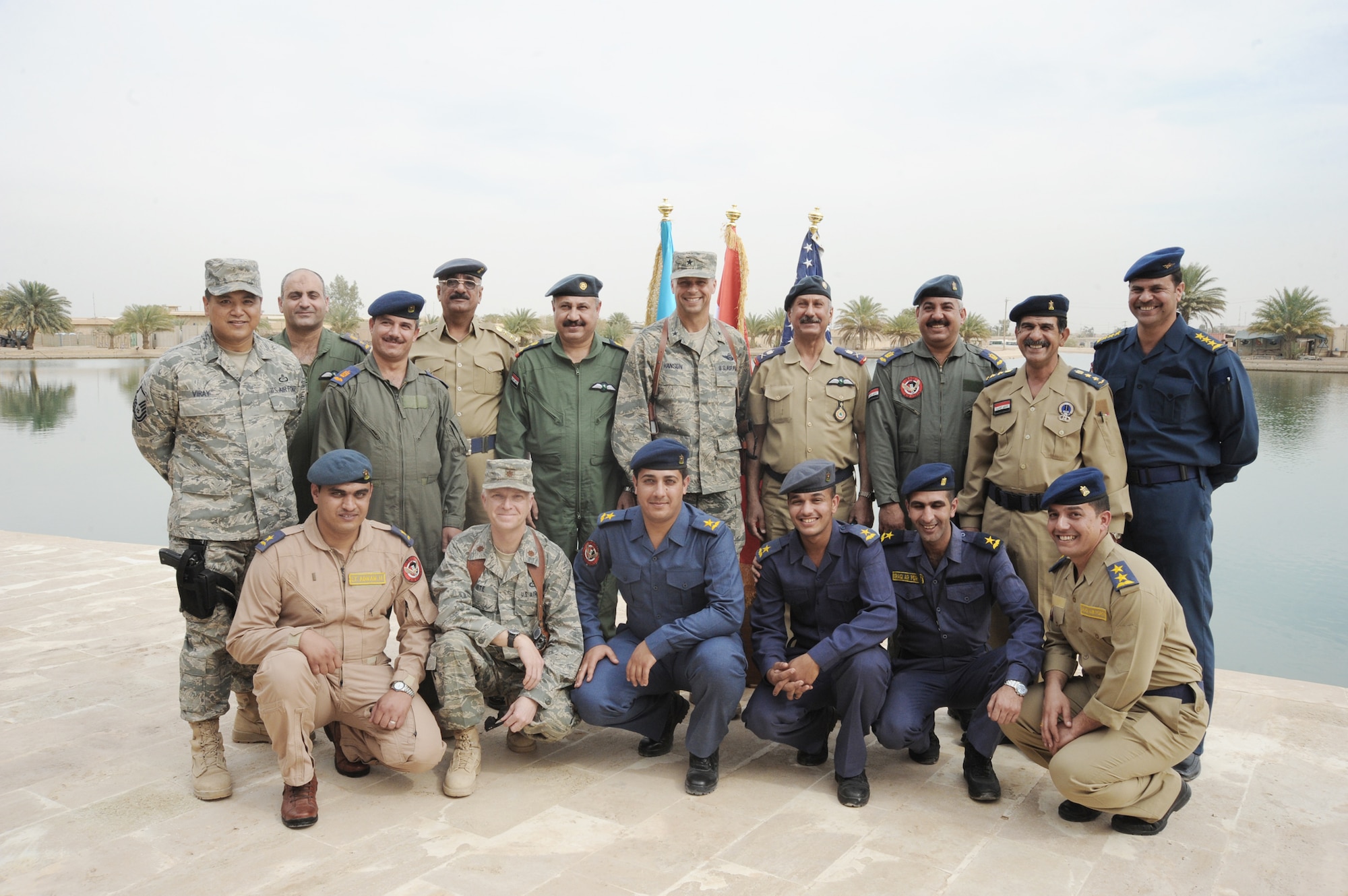 Iraqi air force officers pose with their U.S. Air Force instructors at Camp Victory, Iraq, March 25, 2010, following their graduation from a 52-day meteorology course. The graduates will be sent to different locations throughout Iraq for 30 days of on-the-job training. Once the training is complete, some of the weather advisory officers will become instructors while others will begin their weather advisory mission for the Iraqi military. (U.S. Air Force photo/Master Sgt. Trish Bunting)