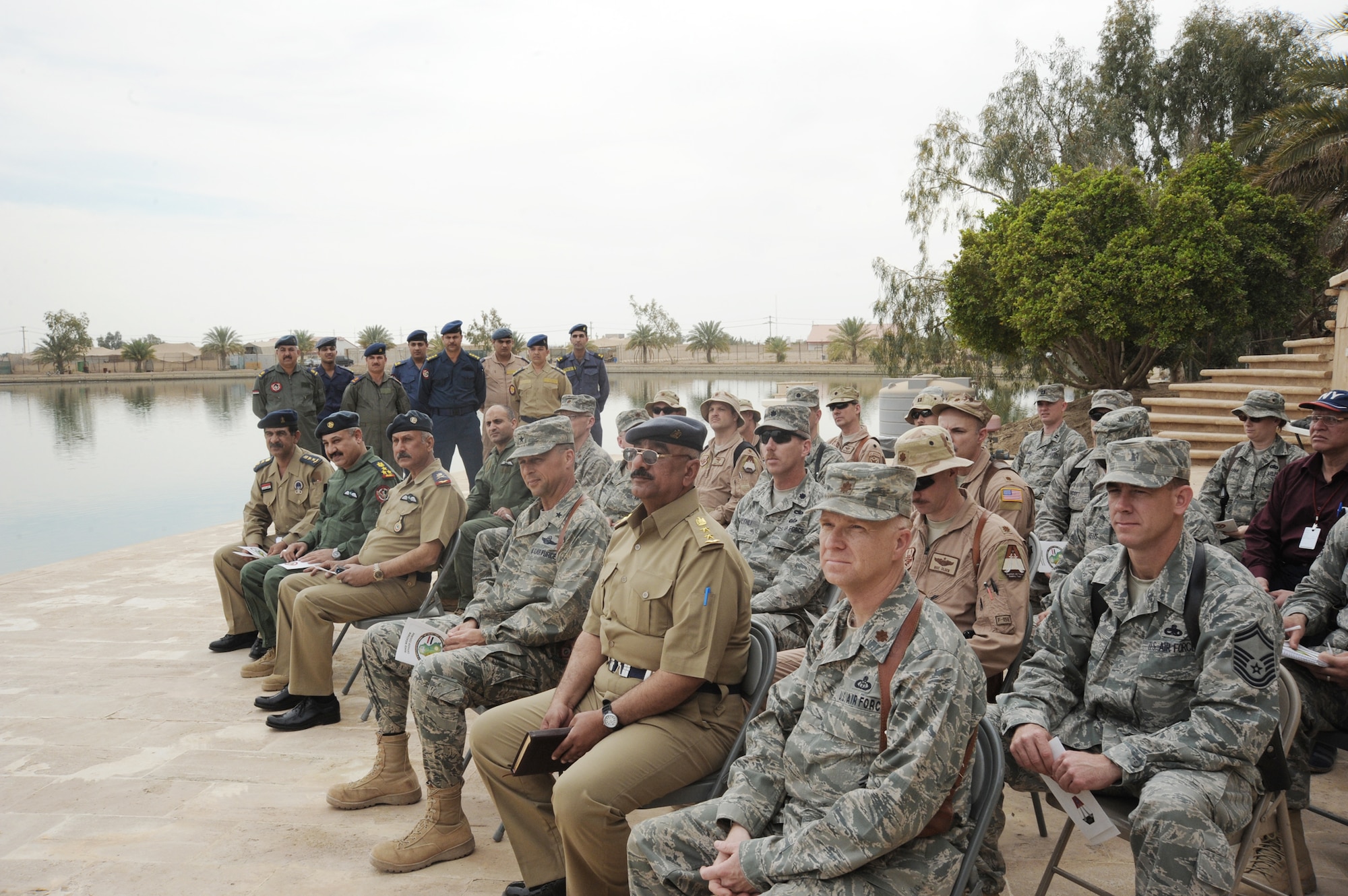 A crowd gathers at Camp Victory, Iraq, March 25, 2010, for the graduation of the first class of Iraqi air force meteorology officers. The graduates will be sent to different locations throughout Iraq for 30 days of on-the-job training. Once the training is complete, some of the weather advisory officers will become instructors while others will begin their weather advisory mission for the Iraqi military. (U.S. Air Force photo/Master Sgt. Trish Bunting)