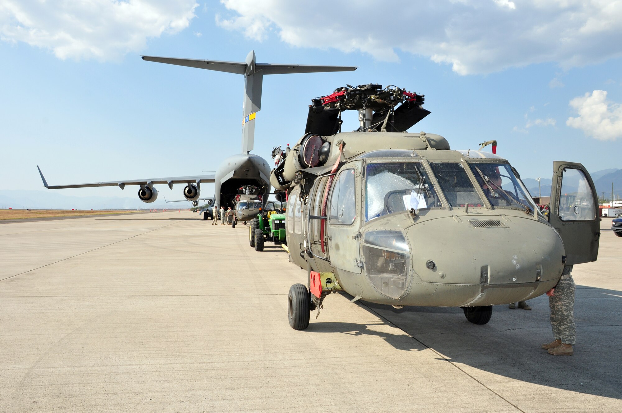 Joint Task Force- Bravo members load a C-17 Globemaster III with UH-60 Blackhawks and equipment March 20, 2010, at Soto Cano Air Base, Honduras. Soto Cano AB officials sent 40 servicemembers and four UH-60 Blackhawks to support Joint Task Force-Haiti airlift operations as part of the disaster relief mission Operation Unified Response. (U.S. Air Force photo/Staff Sgt. Bryan Franks)