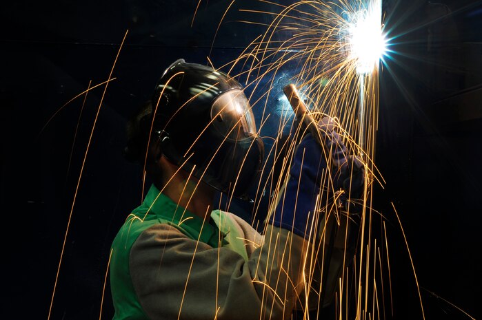U.S. Air Force Airman 1st Class James Moreland welds a vertical arc on a piece of metal at the Aircraft Metals Technology Shop on Joint Base Charleston, March 30, 2010. Technicians assigned to the shop perform welding on ground support equipment and fabricate parts for the C-17 aircraft within factory specifications. Technicians are responsible for removing C-17 hardware such as screws, bolts and change inserts. Airman Moreland is a metals technology apprentice with the 437th Maintenance Squadron. (U.S. Air Force photo by James M. Bowman/released)