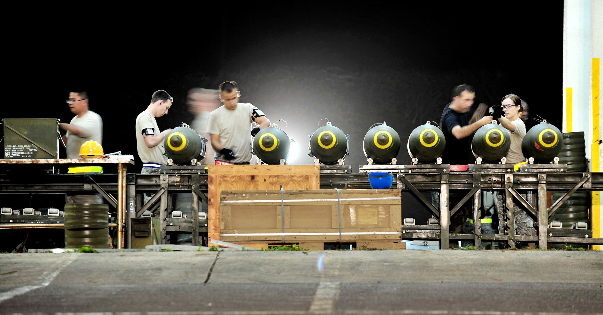 Airmen from the 18th Munitions Squadron build Mark-83 bomb bodies during a base exercise March 24, 2010, at Kadena Air Base, Japan. The 18th Wing participated in a local operational readiness exercise to test base Airmen's ability to defend Japan and maintain peace and stability in the Pacific region. (U.S. Air Force photo/Tech. Sgt. Rey Ramon)