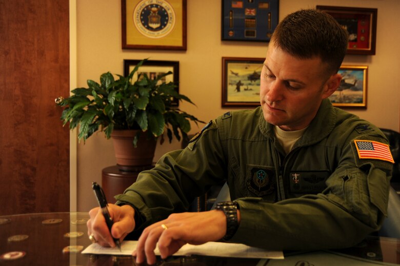 Col. Greg Lengyel, 1st Special Operations Wing commander, signs a payroll plan form in support of the Air Force Assistance Fund campaign at Hurlburt Field March 24, 2010. The AFAF's mission is to raise funds for the charitable affiliates that support Air Force families in need. (U.S. Air Force photo by Senior Airman Matthew Loken)