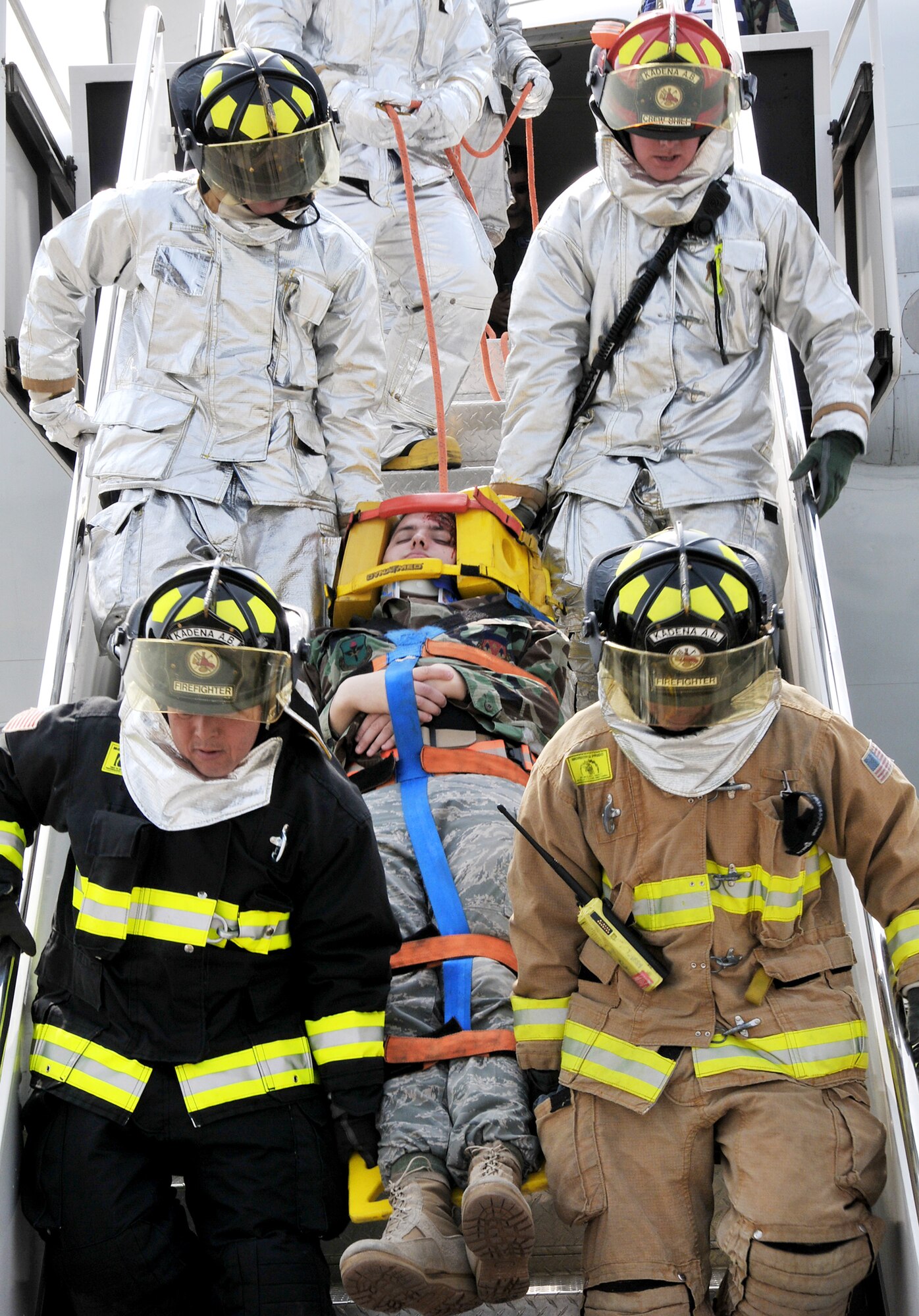 The Kadena Fire Department staff extract an injured victim during a simulation involving a 961st Airborne Warning and Control System E-3 Sentry engine fire during a base exercise March 23, 2010, at Kadena Air Base, Japan. The 18th Wing participated in a local operational readiness exercise to test base Airmen's ability to defend Japan and maintain peace and stability in the Pacific region. (U.S. Air Force photo/Tech. Sgt. Angelique Perez)
