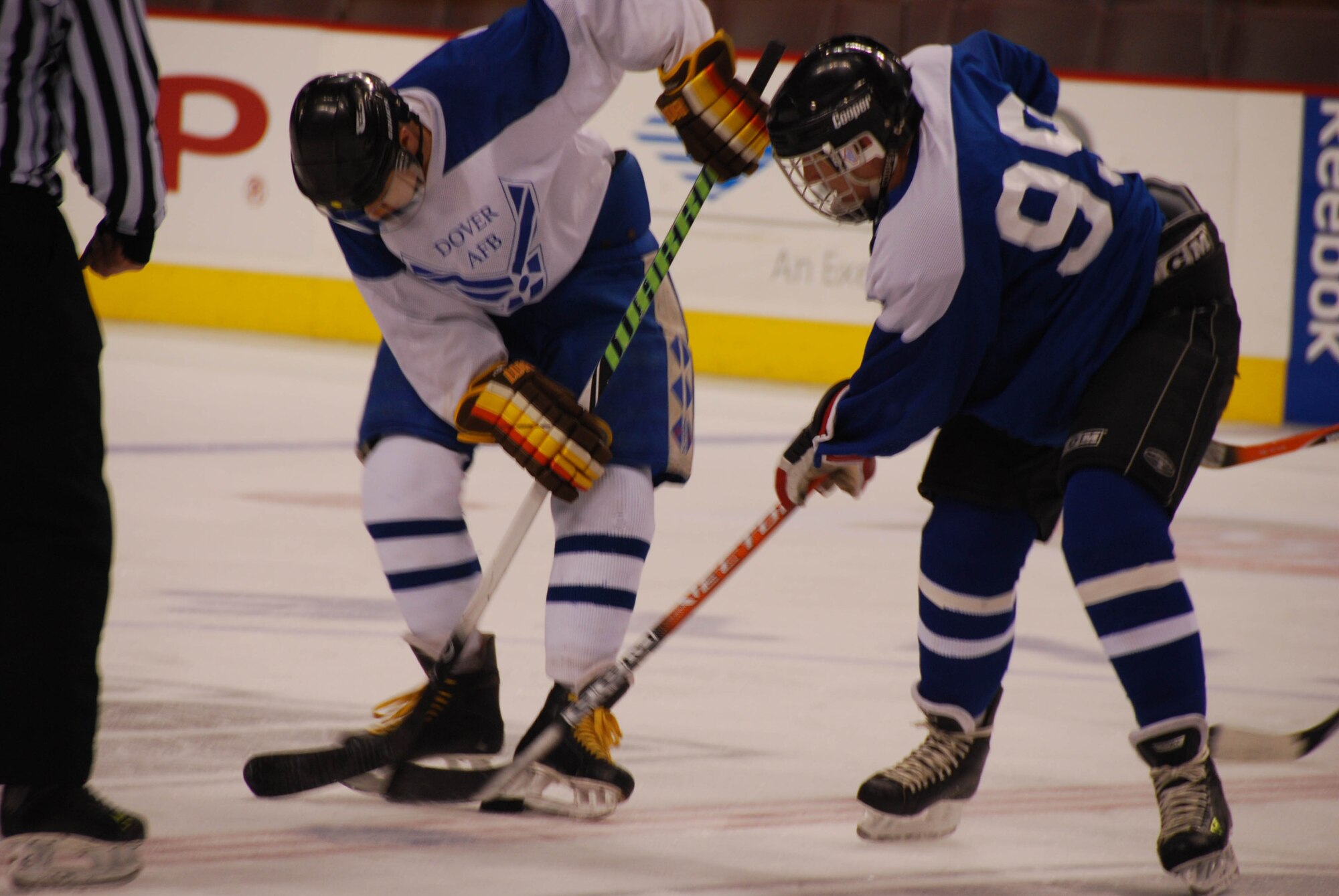 JOINT BASE MCGUIRE-DIX-LAKEHURST, N.J. -- Joint Base McGuire-Dix-Lakehurst All-Stars center, Lt. Col. Andrew Kittleson, (right), takes the puck during the 2010 "Battle on the Ice for Charity" hockey game held March 28 at the Wachovia Center in Philadelphia, PA. JB MDL's 8-6 win over the Dover Air Force Base All-Stars team broke the tie record of one game a piece. Together the ice hockey teams raised $4,500 over the past three years competing in this fundraiser charity match that supports military families in need. Proceeds of the match are donated to the Combined Federal Campaign and Air Force Assistance Fund (U.S. Air Force photo by/Master Sgt. Donna T. Jeffries)