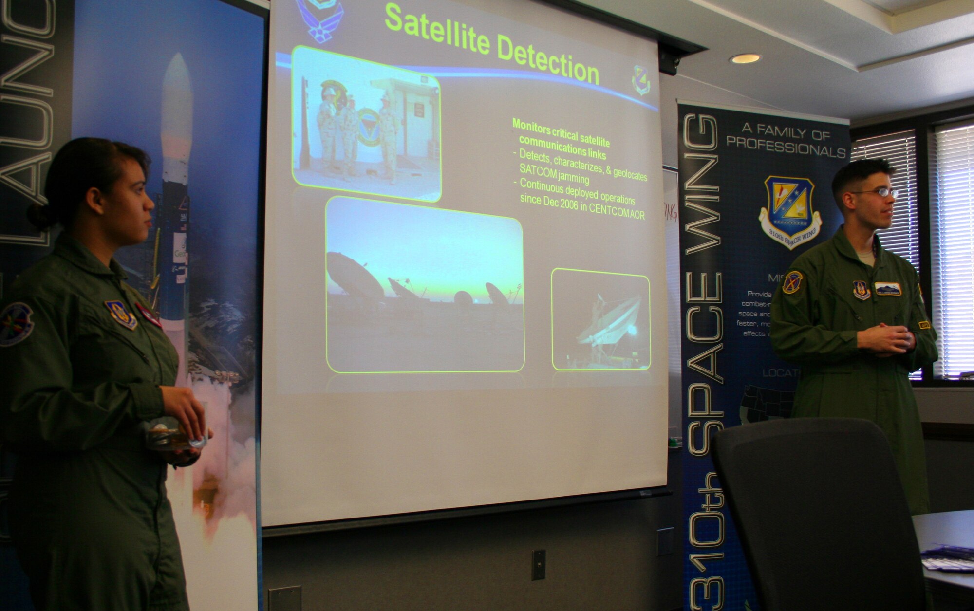 Senior Airman Ann J. Melendez-Martinez, a space operator with 6th Space Operations Squadron, and Senior Airman John C. Burbach, a space operator with 19th Space Operations Squadron, teach cadets from area Air Force Junior Reserve Officer Training Corps about the 310th Space Wing March 17.During an Air Force Reserve day in the life event hosted by the 302nd Airlift Wing at Peterson Air Force Base, Colo.,  over 175 cadets learned about several missions including security forces, aircraft maintenance and aviation specialties. The day was designed to highlight career and education opportunities in the Air Force Reserve. Both Airmen work full-time for the 310th Space Wing at Schriever Air Force Base, Colo. (U.S. Air Force photo by Capt. Maren P. Barney)