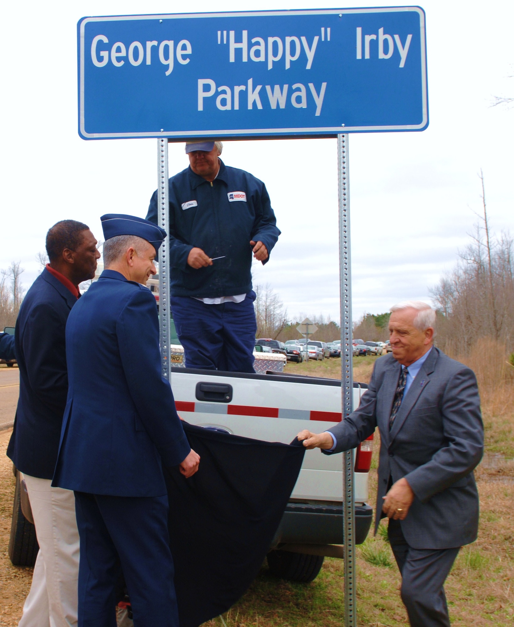 Col. Roger Watkins, 14th Flying Training Wing commander, and George Irby, Director of Federal Programs for the City of Columbus and the son of George “Happy” Irby, unveil one of the new signs marking the main road into Columbus AFB the George “Happy” Irby parkway. “Happy” Irby passed away on his 94th birthday, March 27, 2009. (U.S. Air Force photo/Elizabeth Owens). 